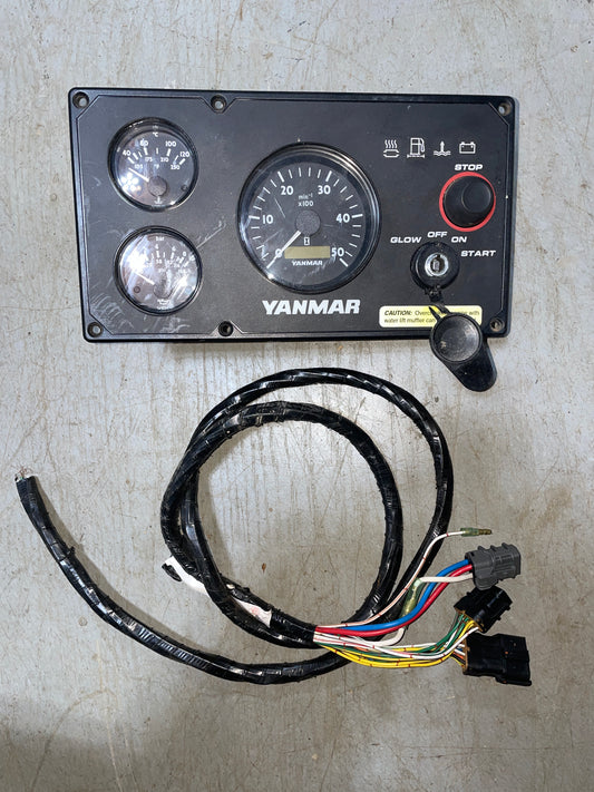 Yanmar gauge panel with wiring harness on a concrete surface