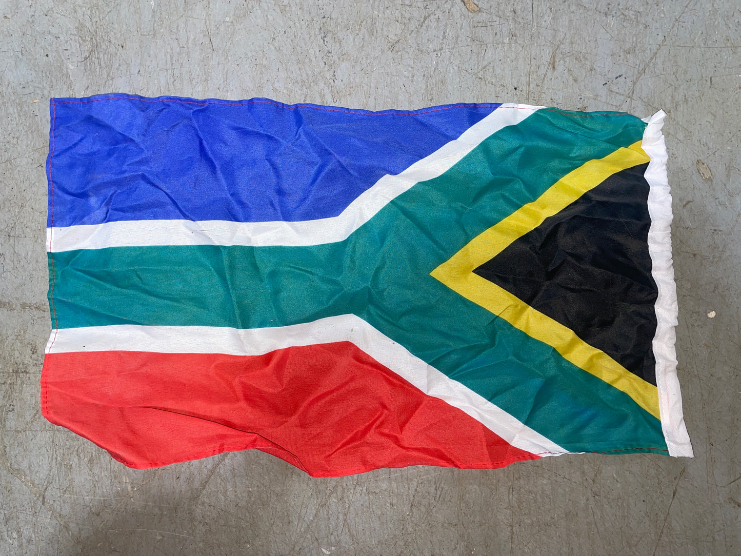 South African flag on a textured gray surface
