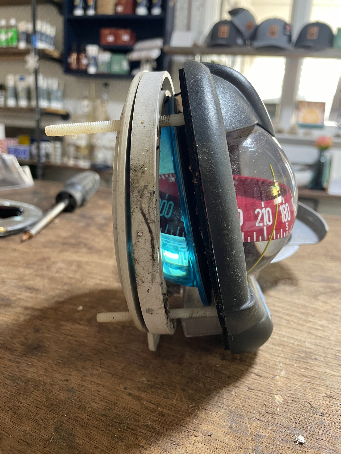 Small electronic device with a dial on a wooden surface, blurred background