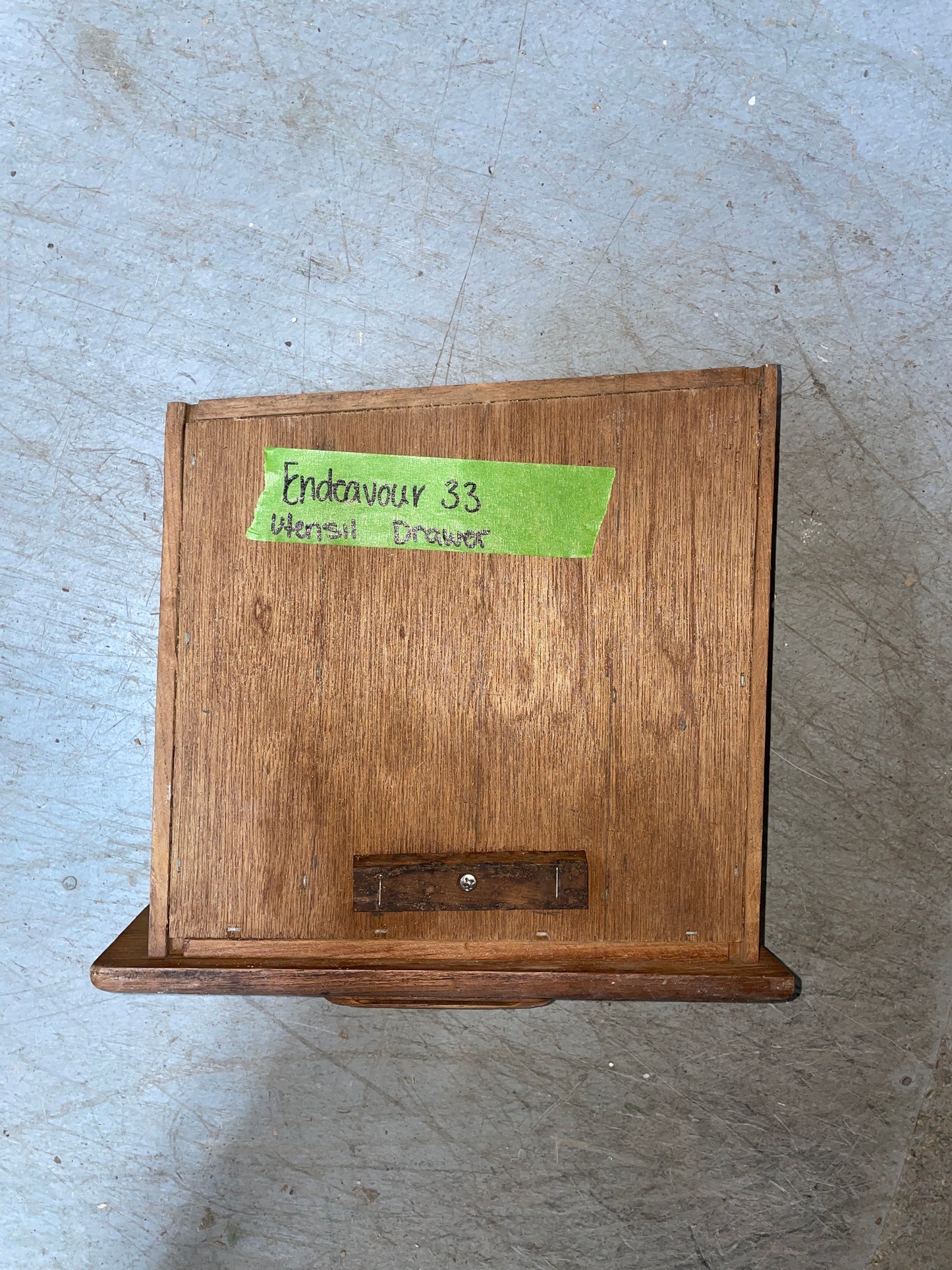 Wooden box with a green label on a concrete surface