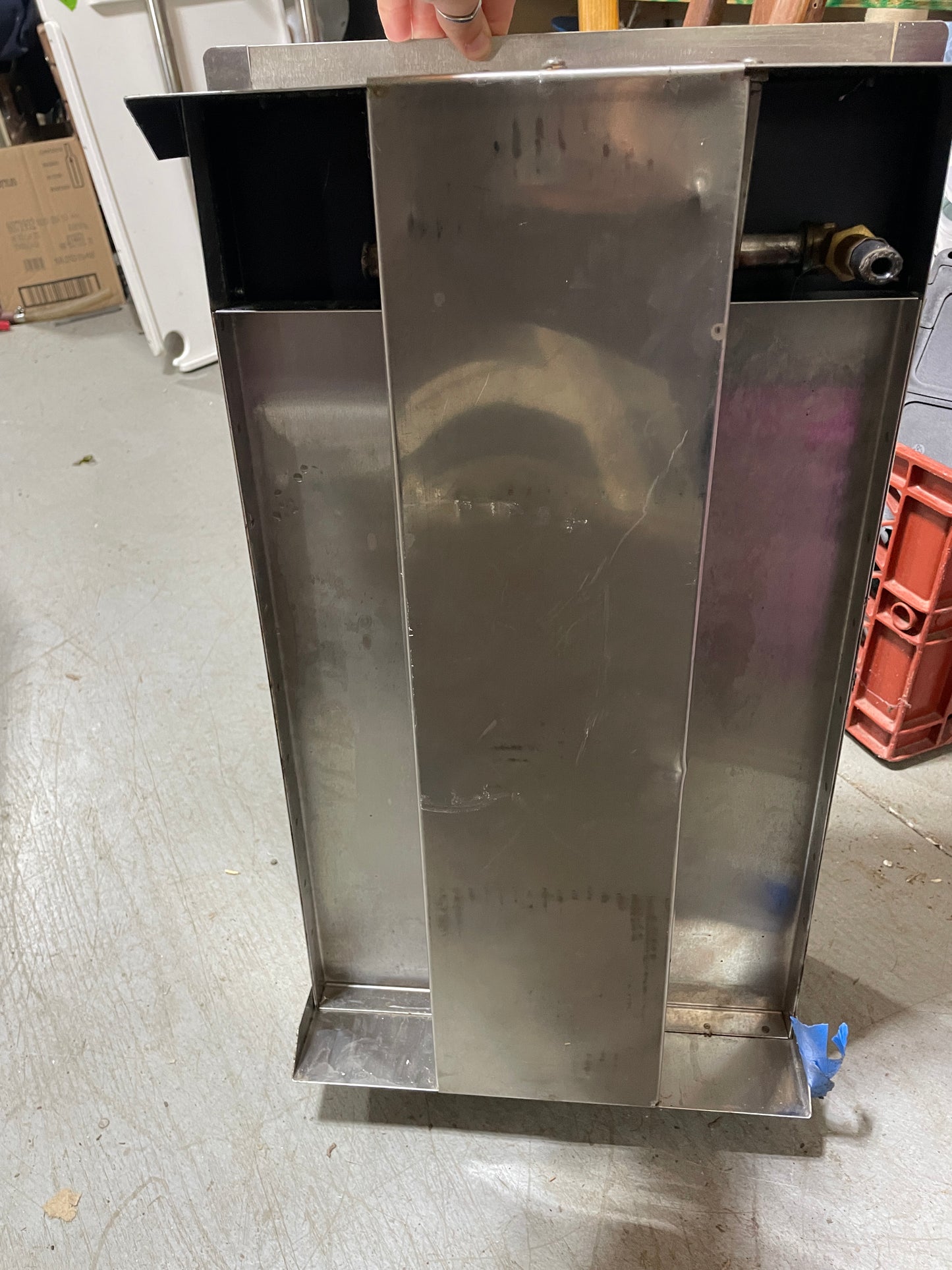 Metallic object with a reflective surface on a concrete floor