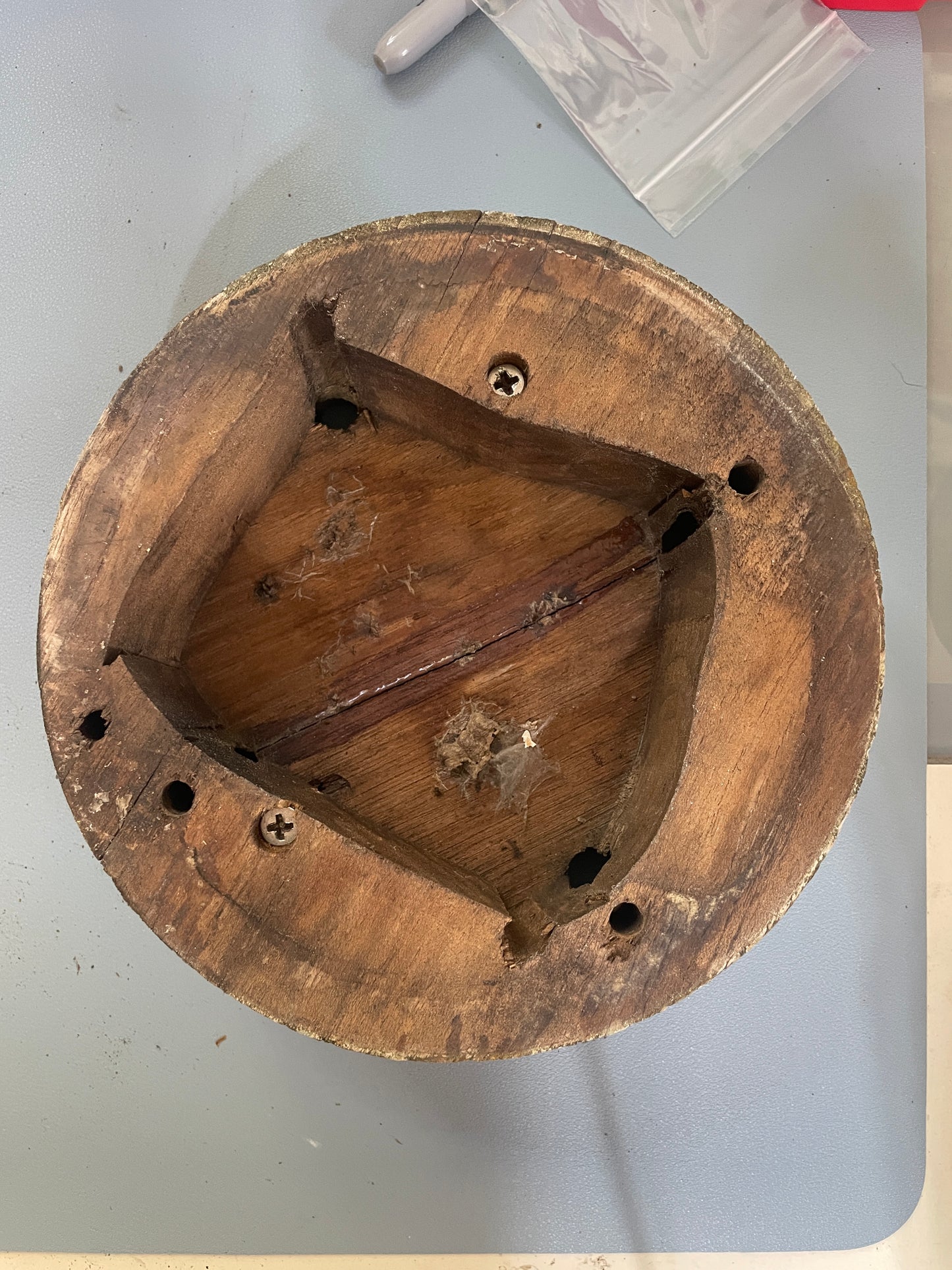 Wooden object with a geometric design on a light gray surface