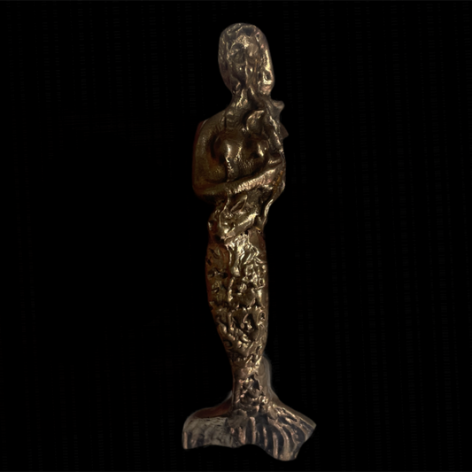 Bronze mermaid figurine on a black background