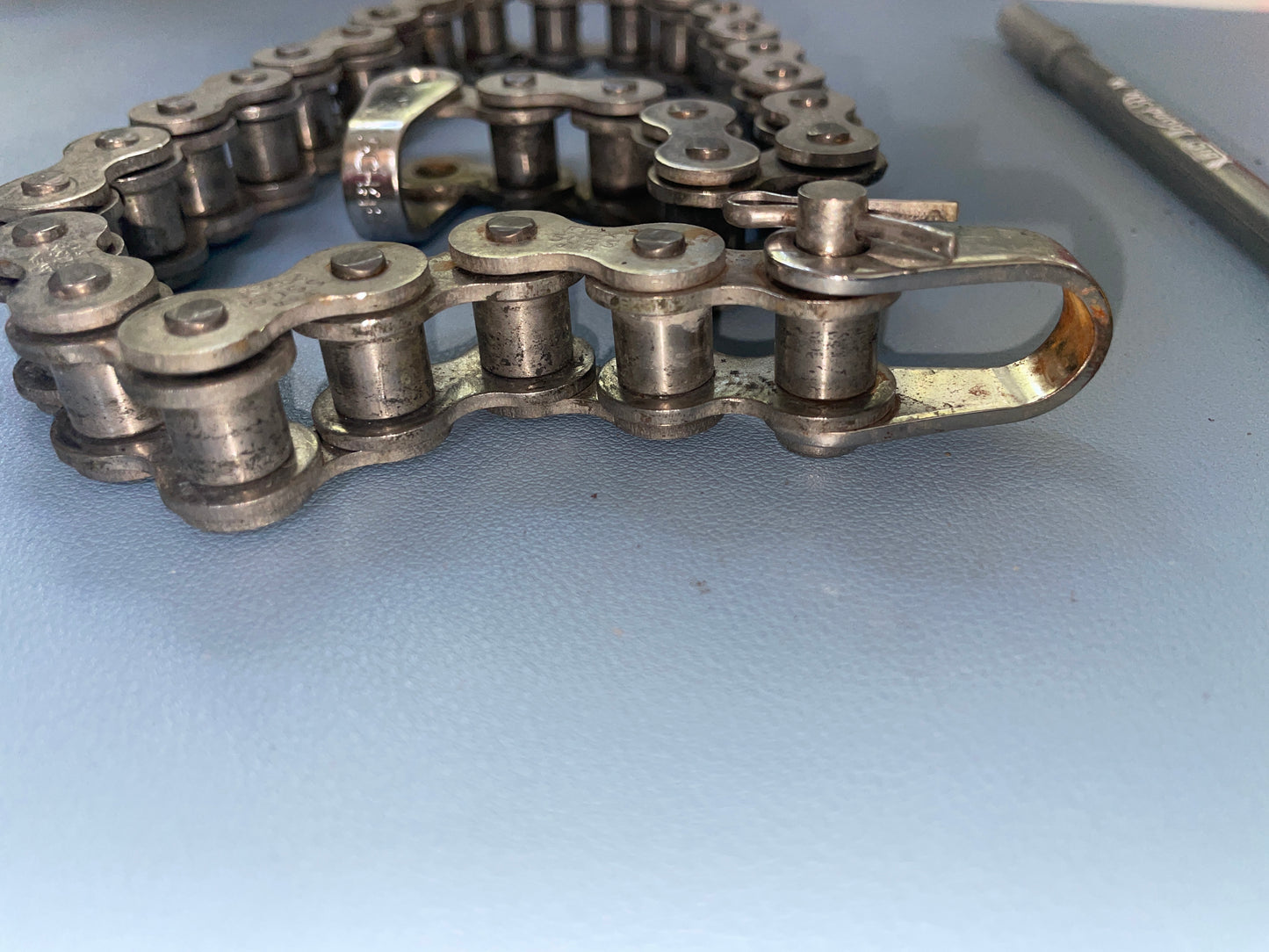 Metal chain on a light blue surface