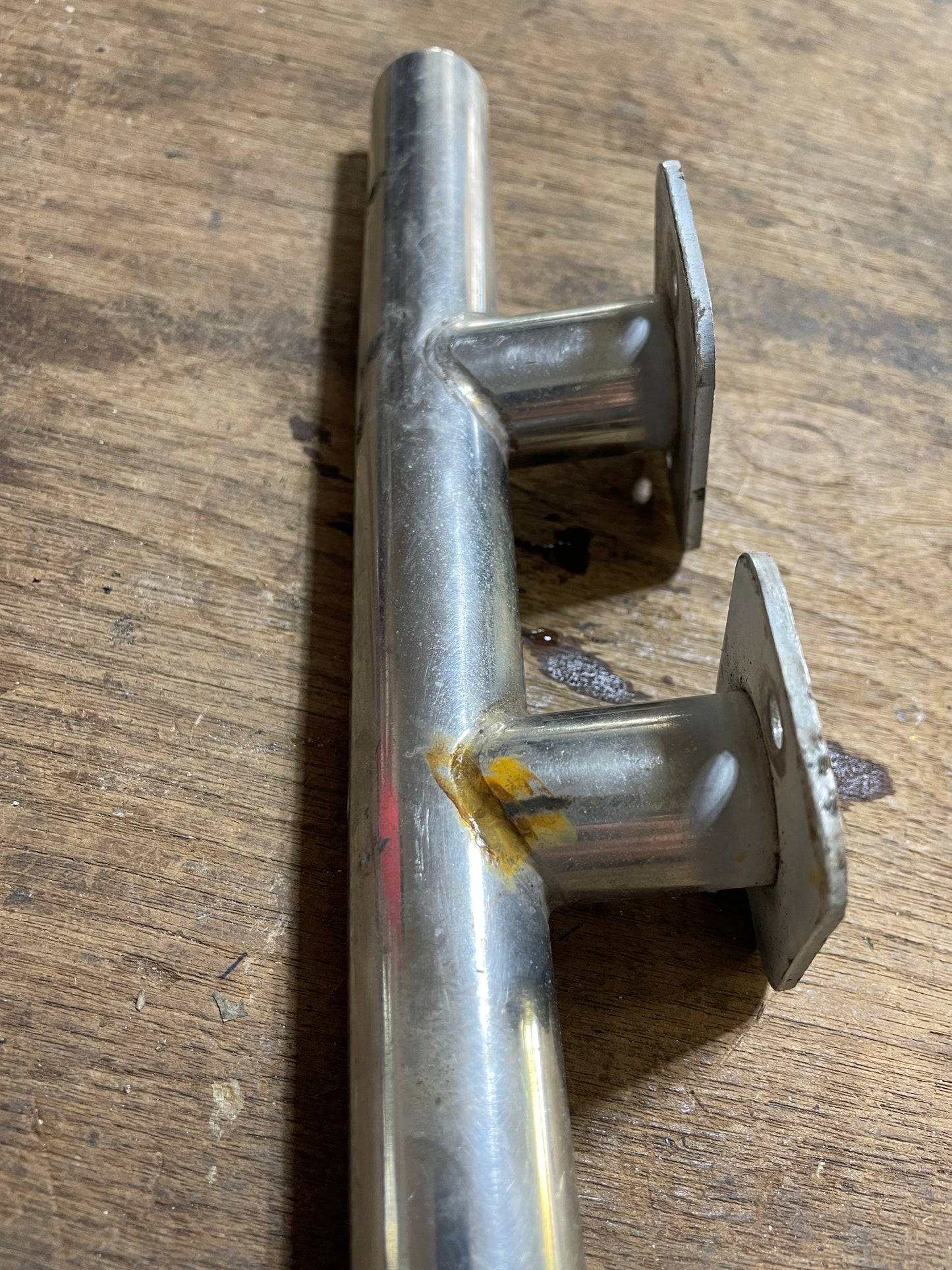 Metal fitting on a wooden surface