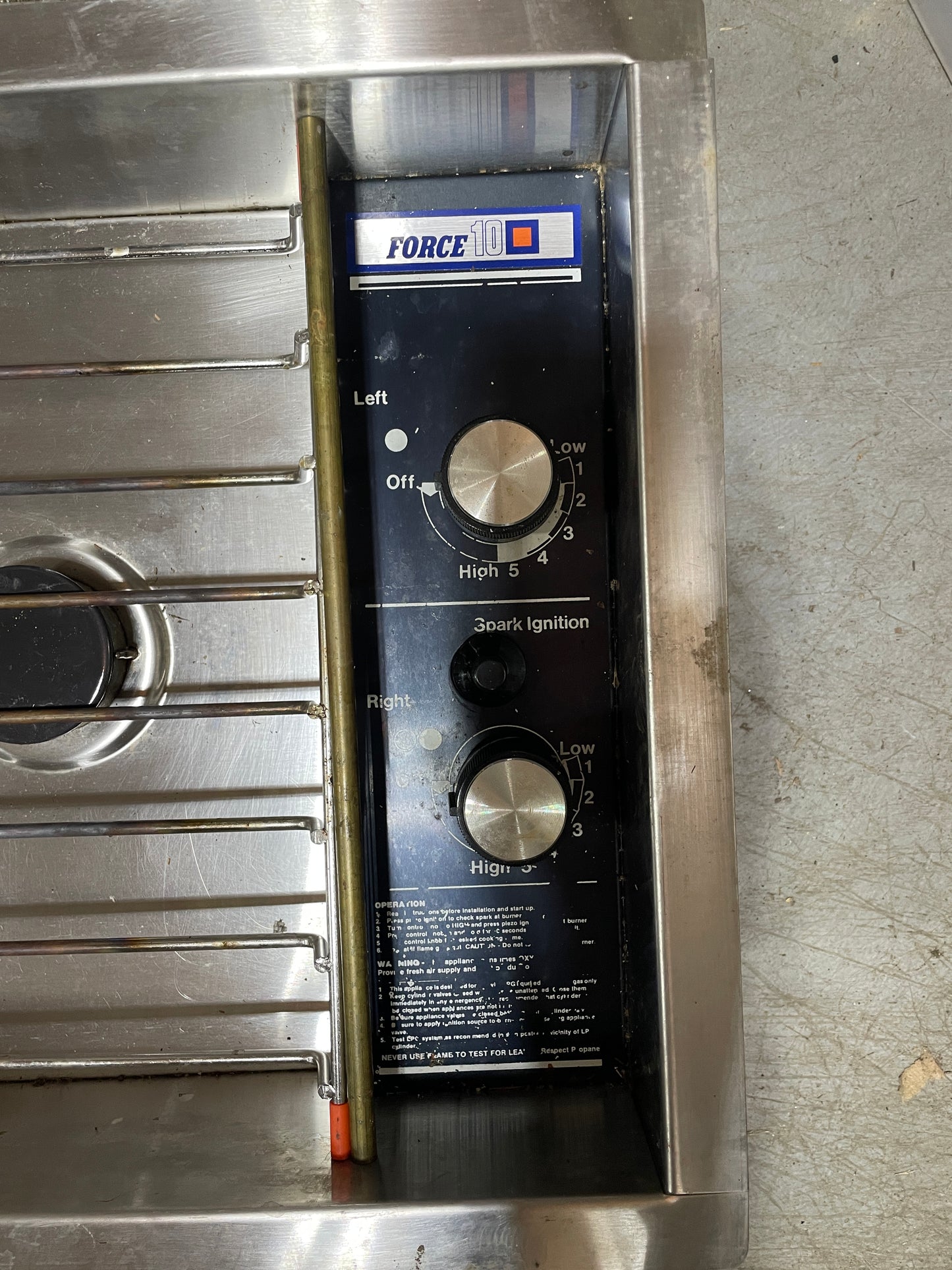 Control panel with knobs and labels on a metallic surface
