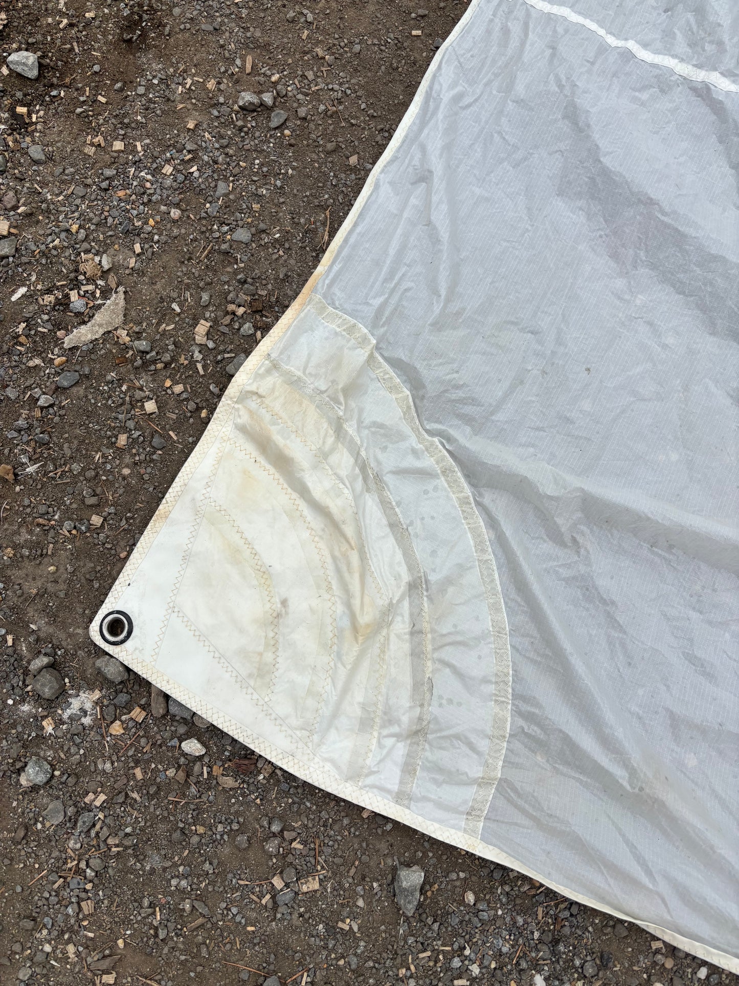 White tarp on a dirt ground