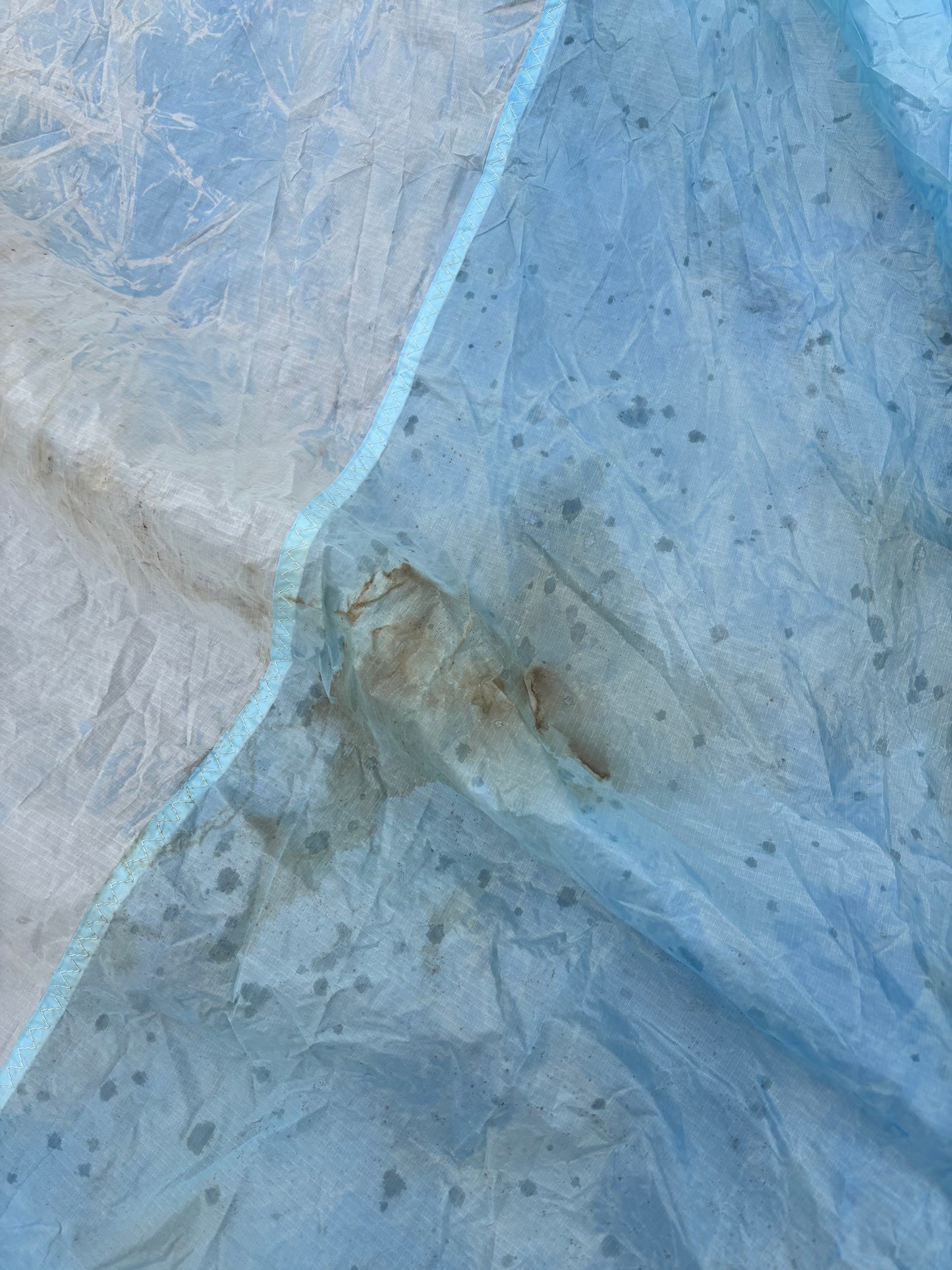 Textured blue and beige surface with a crack running through it