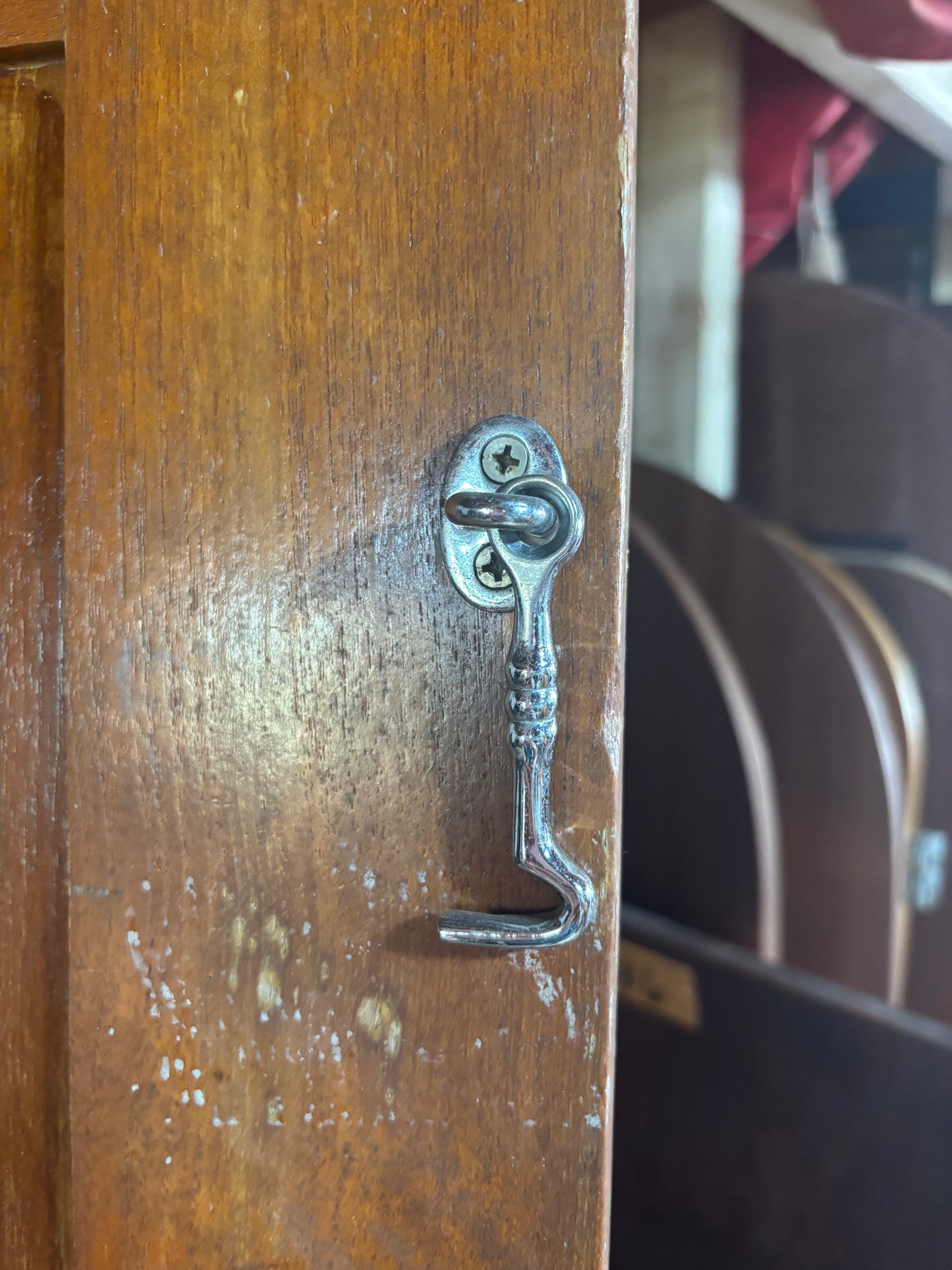 Metal key-shaped latch on a wooden door