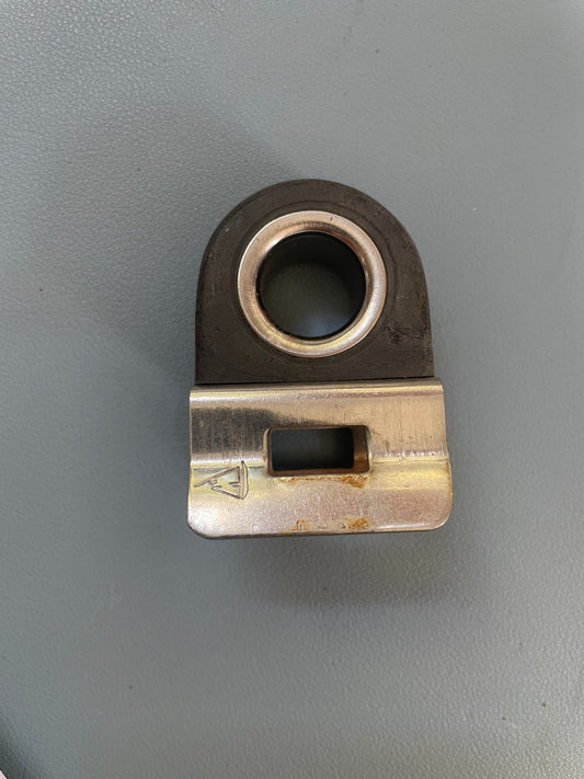 Metal component with a cylindrical hole and rectangular slot on a gray background