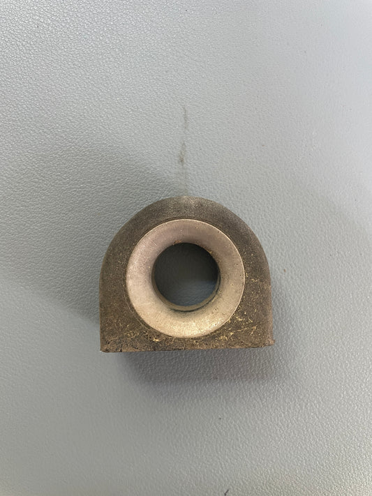 Bronze cylindrical component on a gray background
