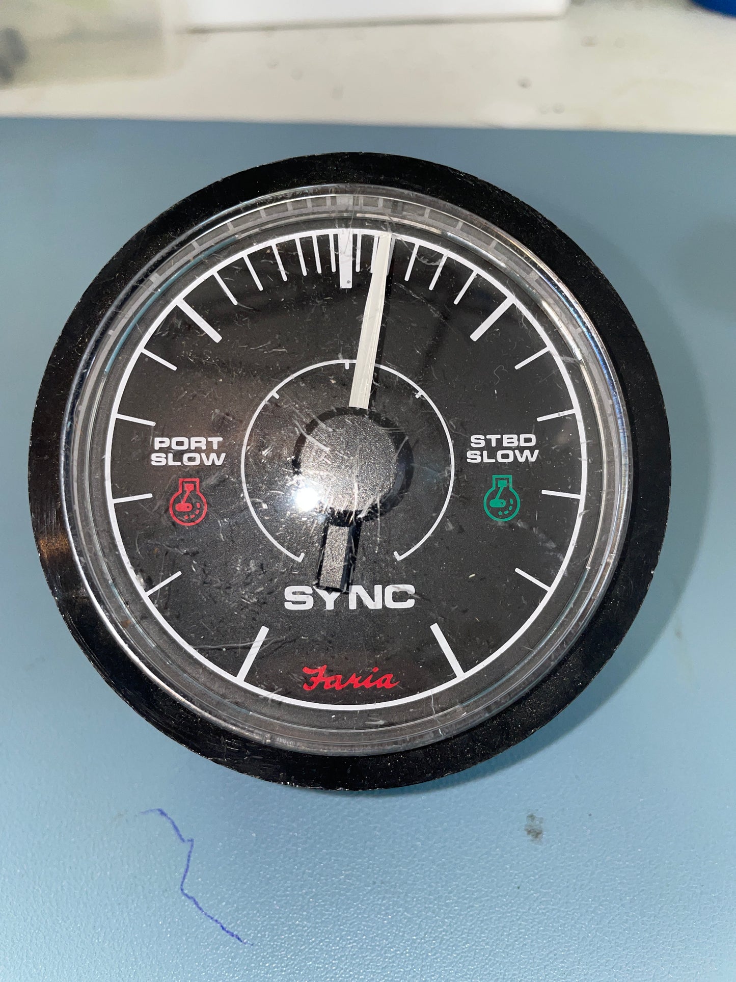 Round dial with 'SYNC' branding on a blue background
