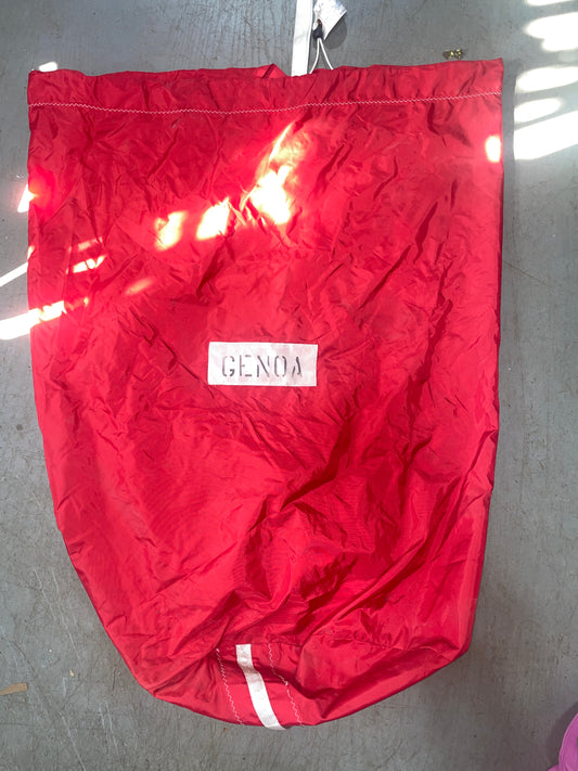 Red bag with a brand label on a gray surface