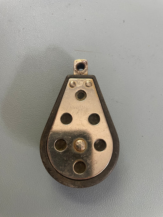 Metal component with holes on a gray background