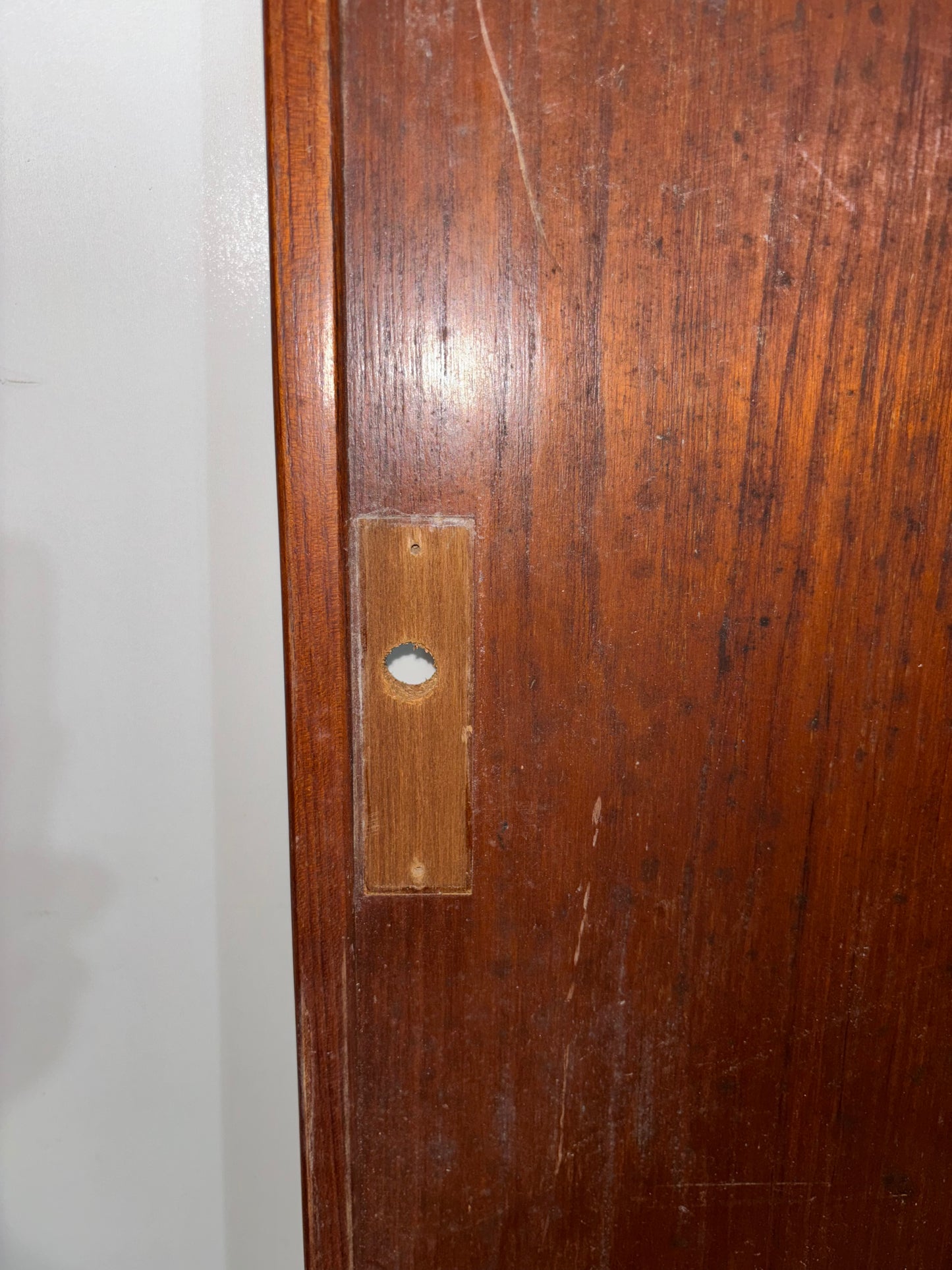Close-up of a wooden door with a metal latch