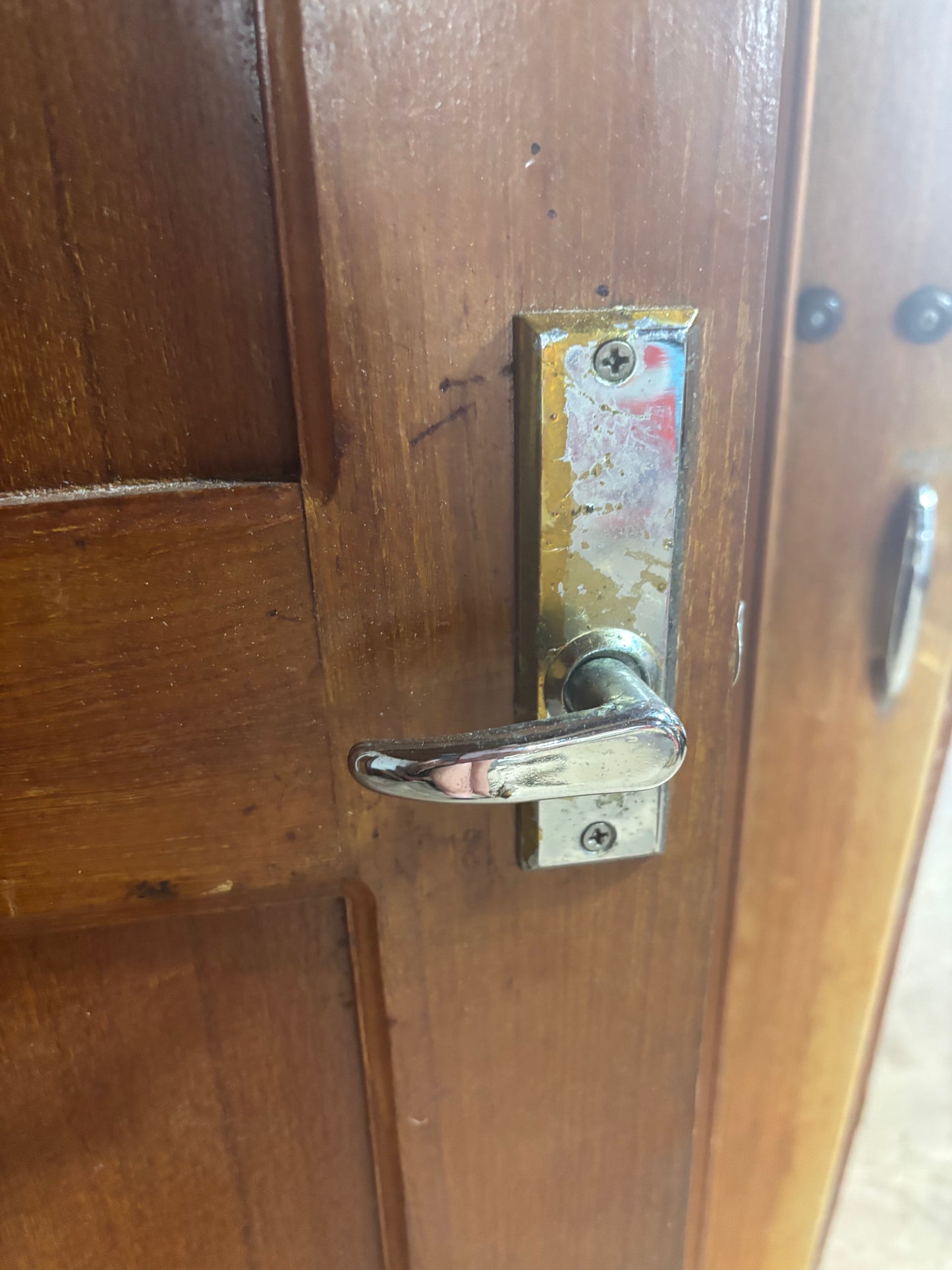 Wooden door with a metal handle and lock