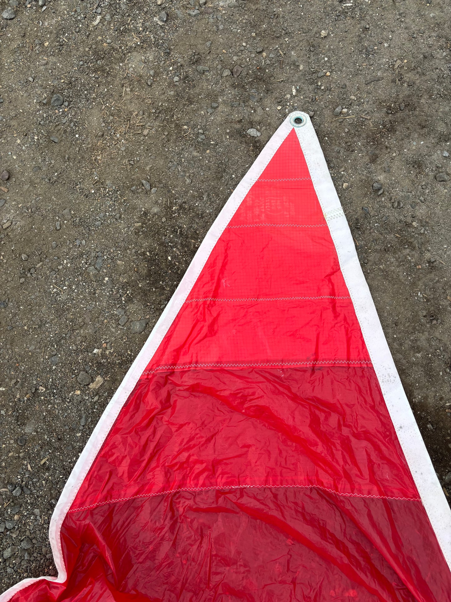 Red triangular flag on a concrete surface