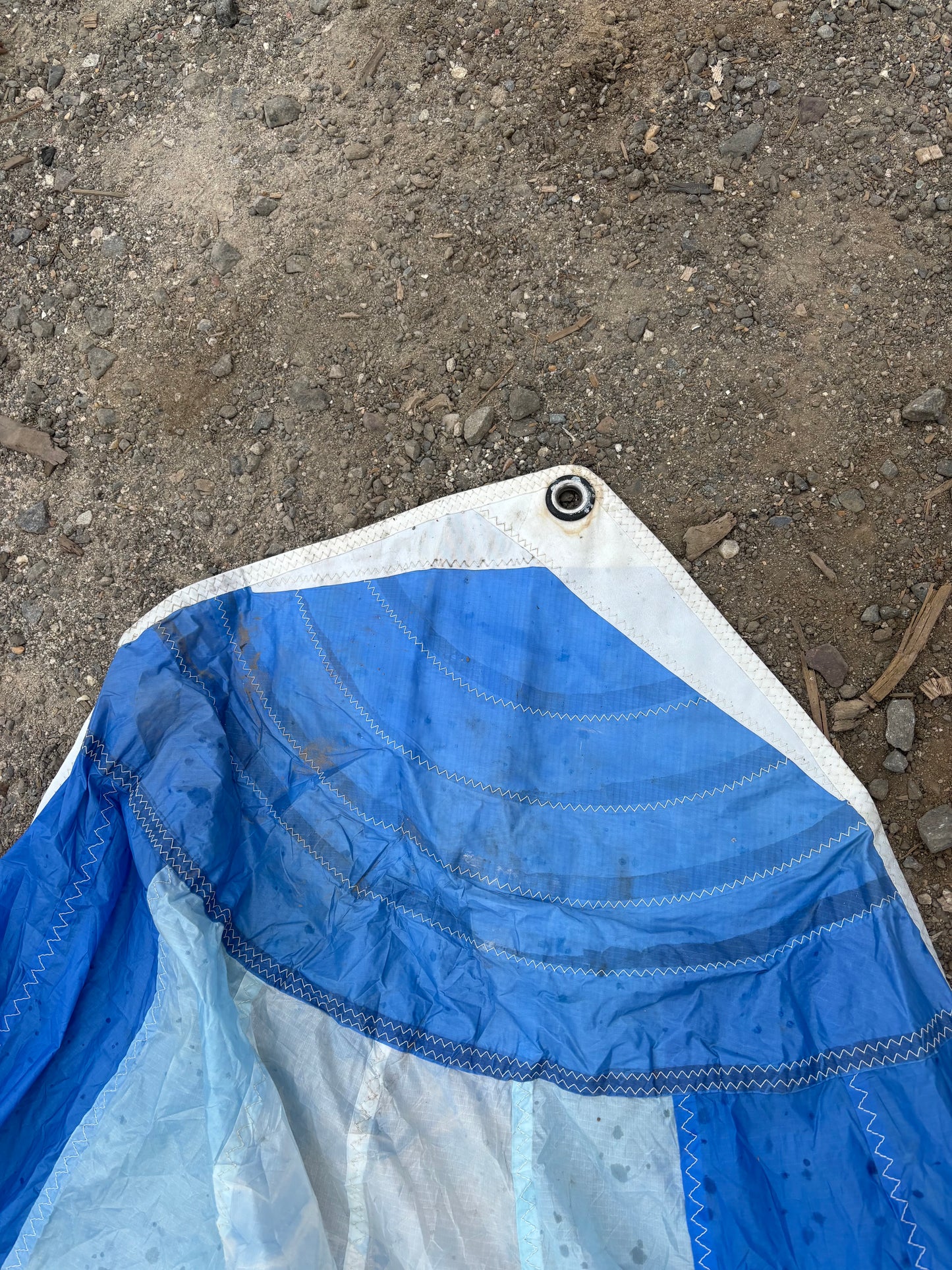 Blue and white sleeping bag corner on a concrete surface