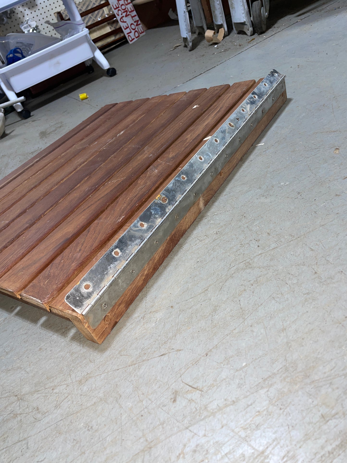 Wooden panel with metal strip on a textured wall