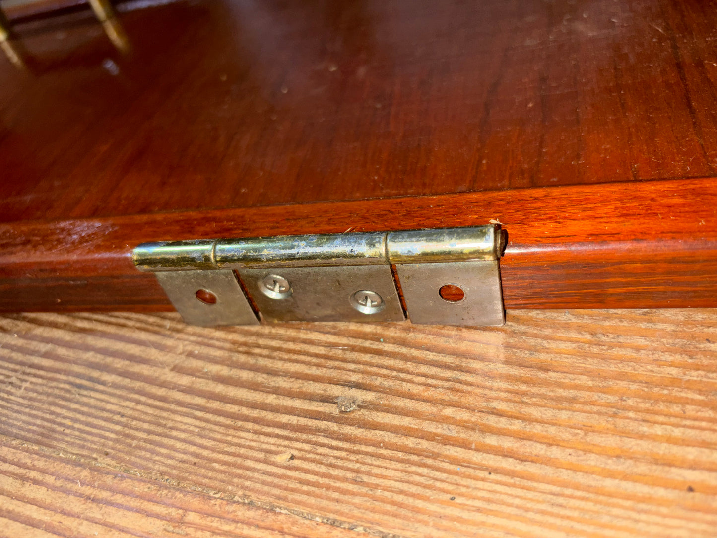 Metal hinge on a wooden surface
