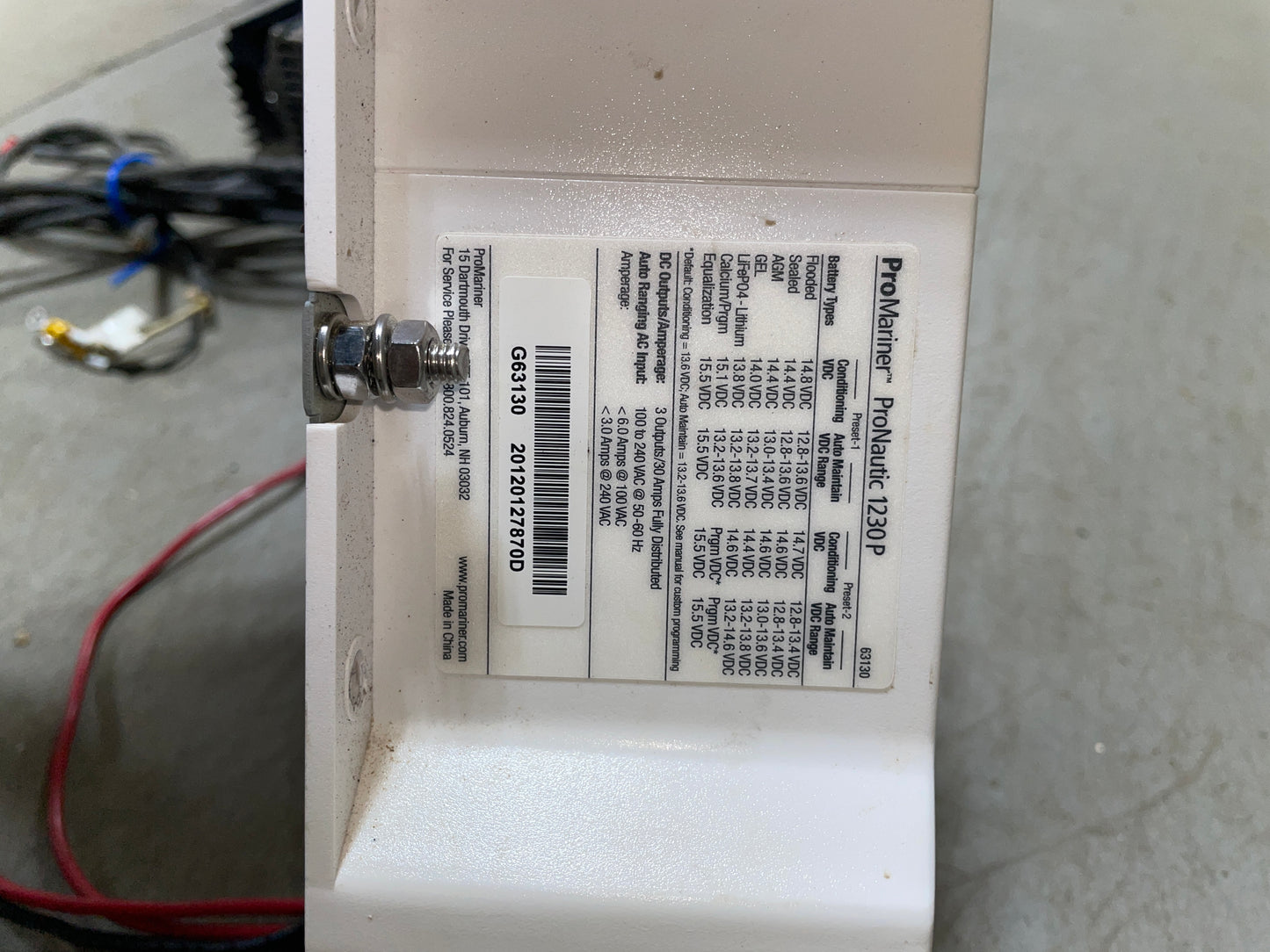 Electrical component with labels and wiring on a concrete floor