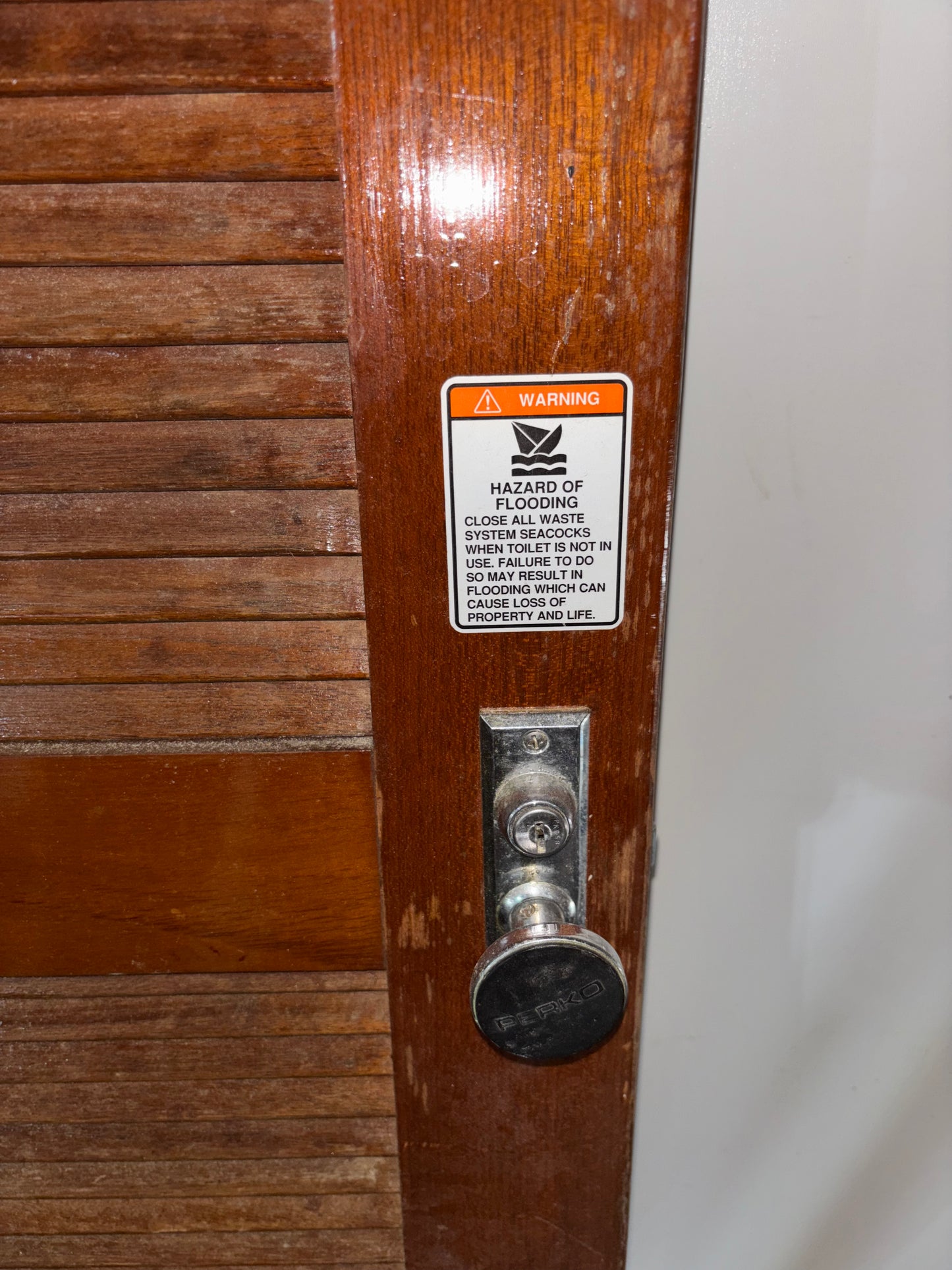 Wooden door with a warning label and lock mechanism