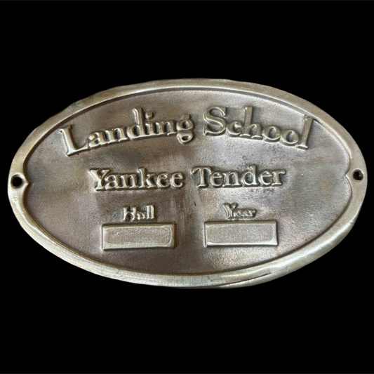 Metal plaque with engraved text on a black background