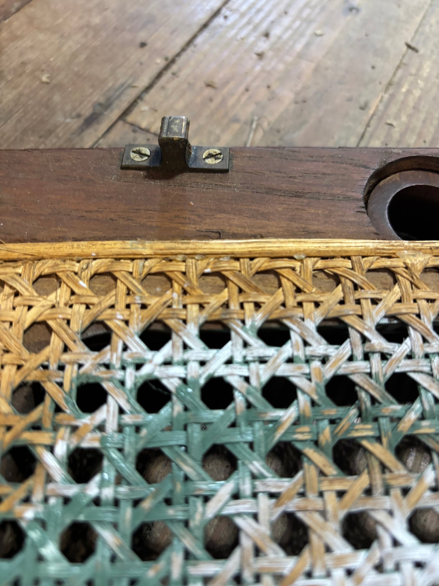 Close-up of a wooden door with a metal handle and intricate lattice design.