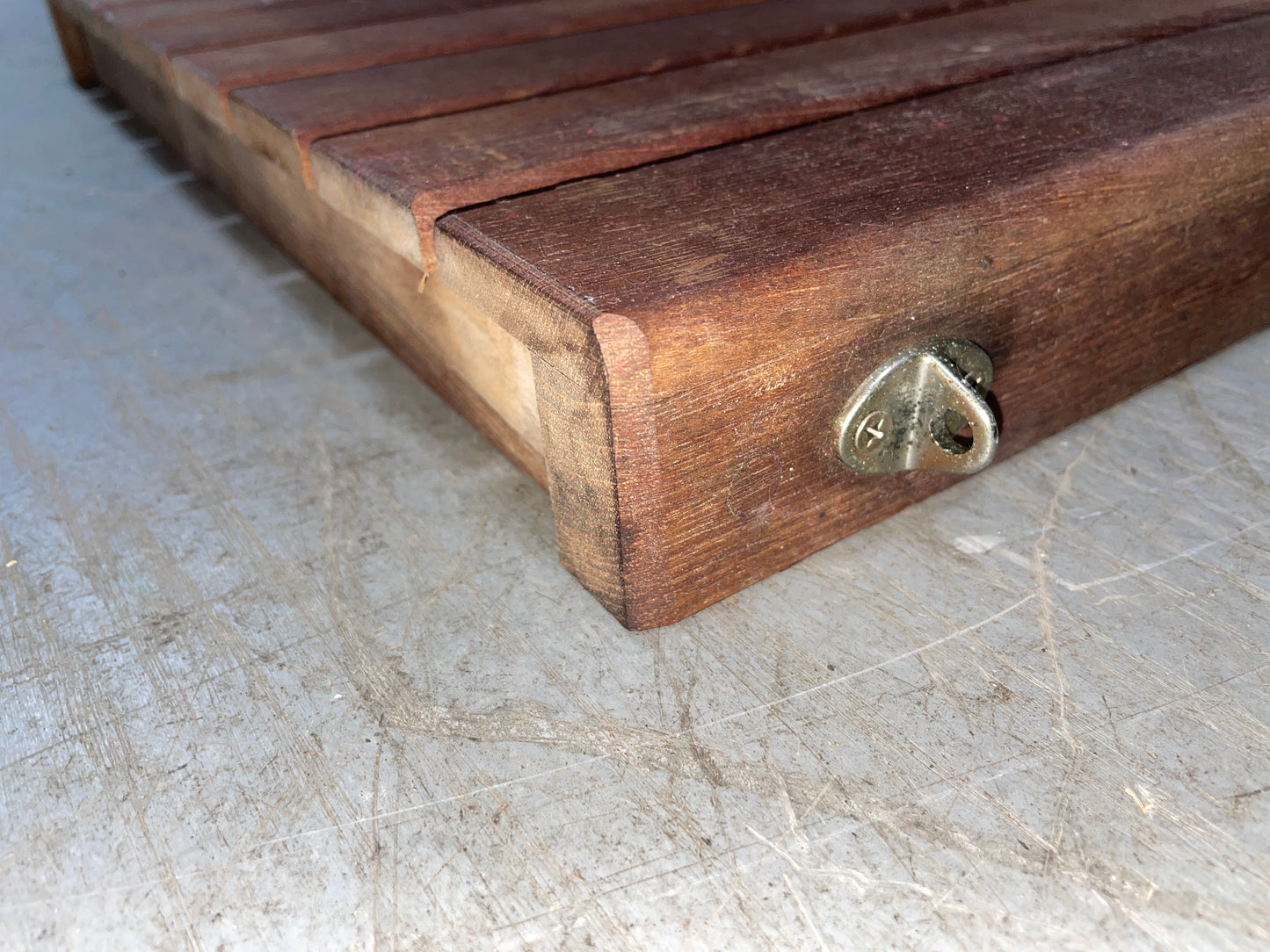 Wooden box with a metal latch on a concrete surface