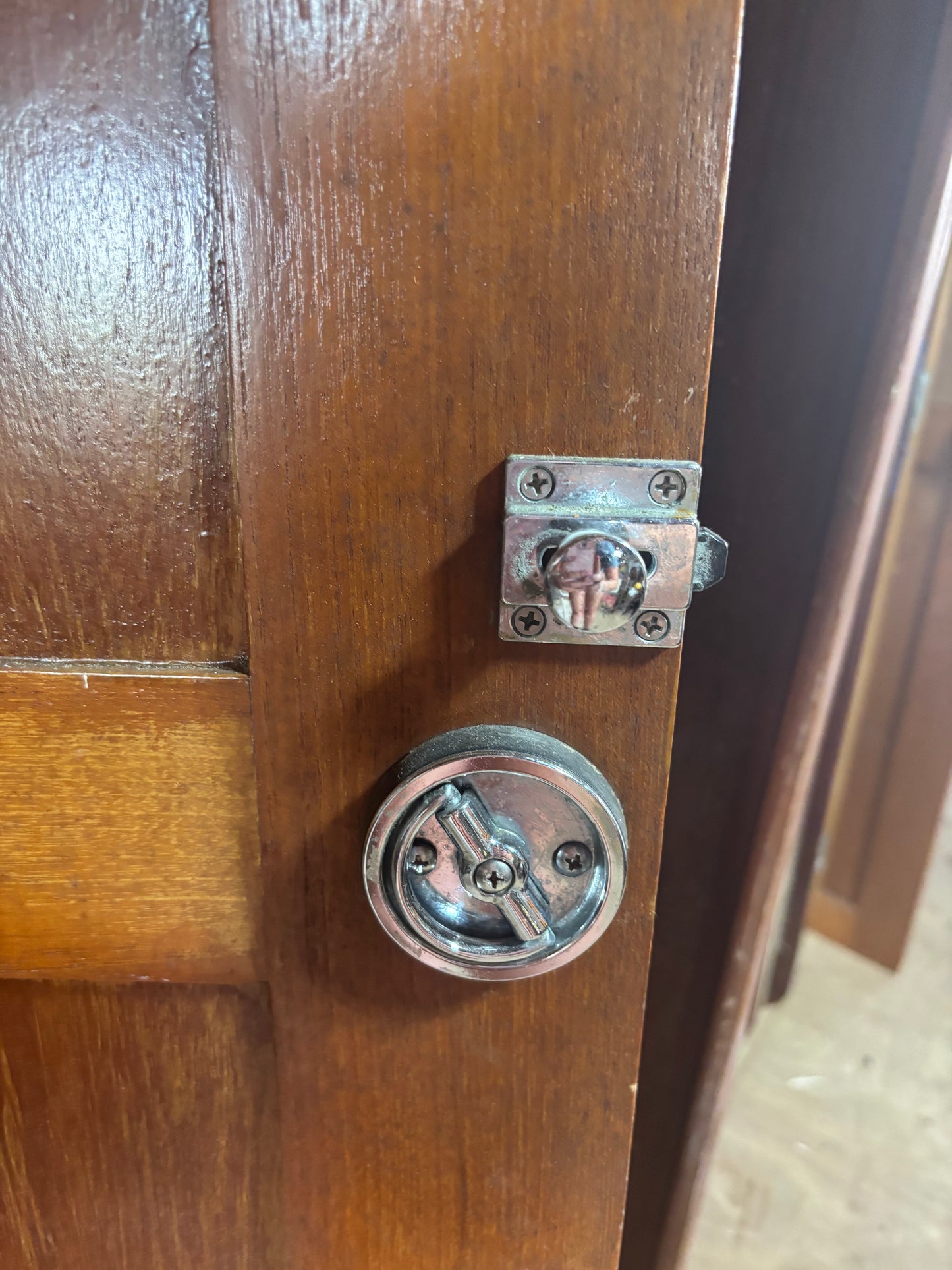 Wooden door with a metal latch and knob