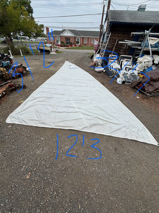 Large white sail with measurements on an outdoor lot