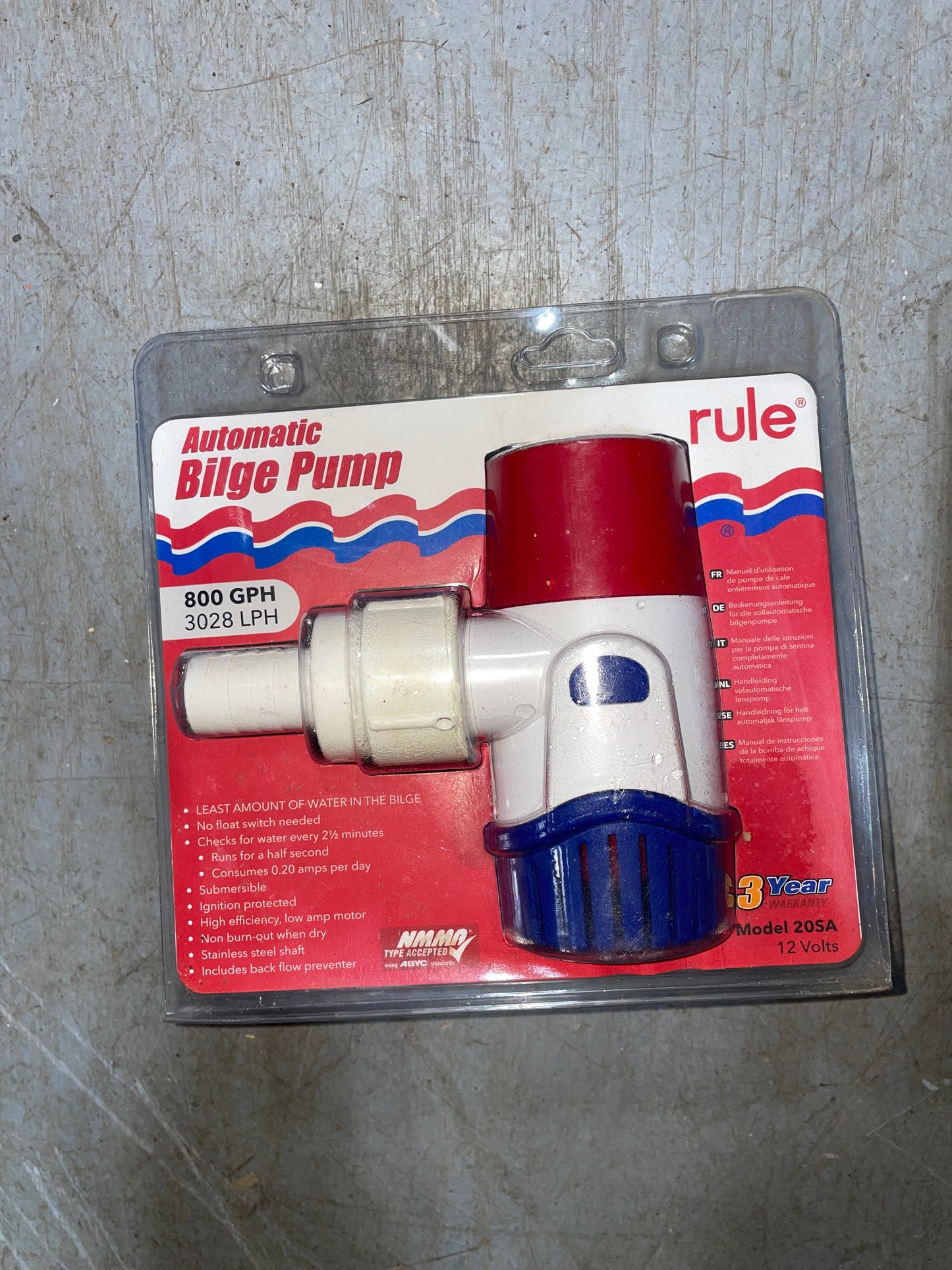 Rule bilge pump on a red label with blue and white accents, on a gray surface.
