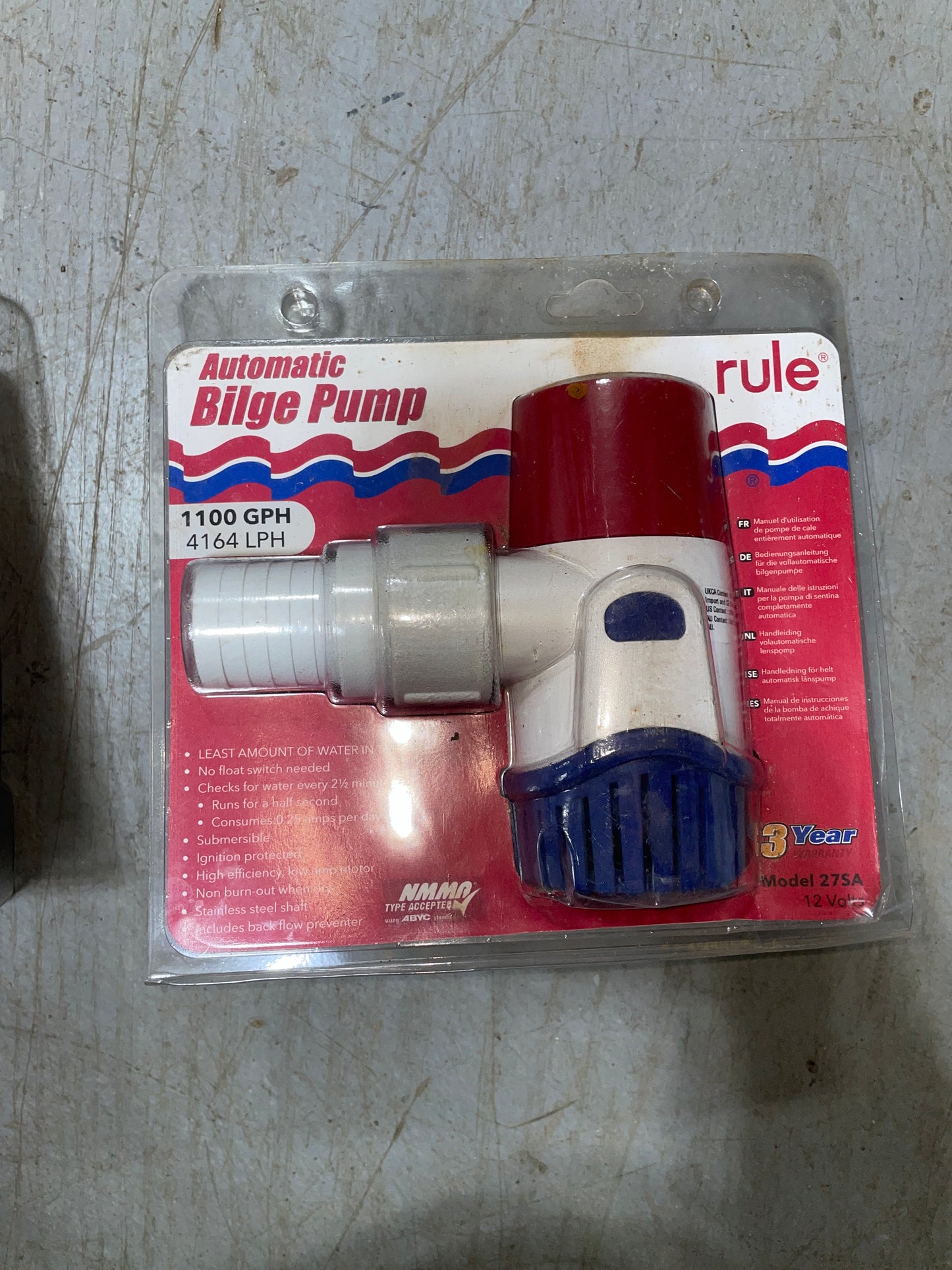 Rule automatic bilge pump on a red and white packaging on a concrete surface