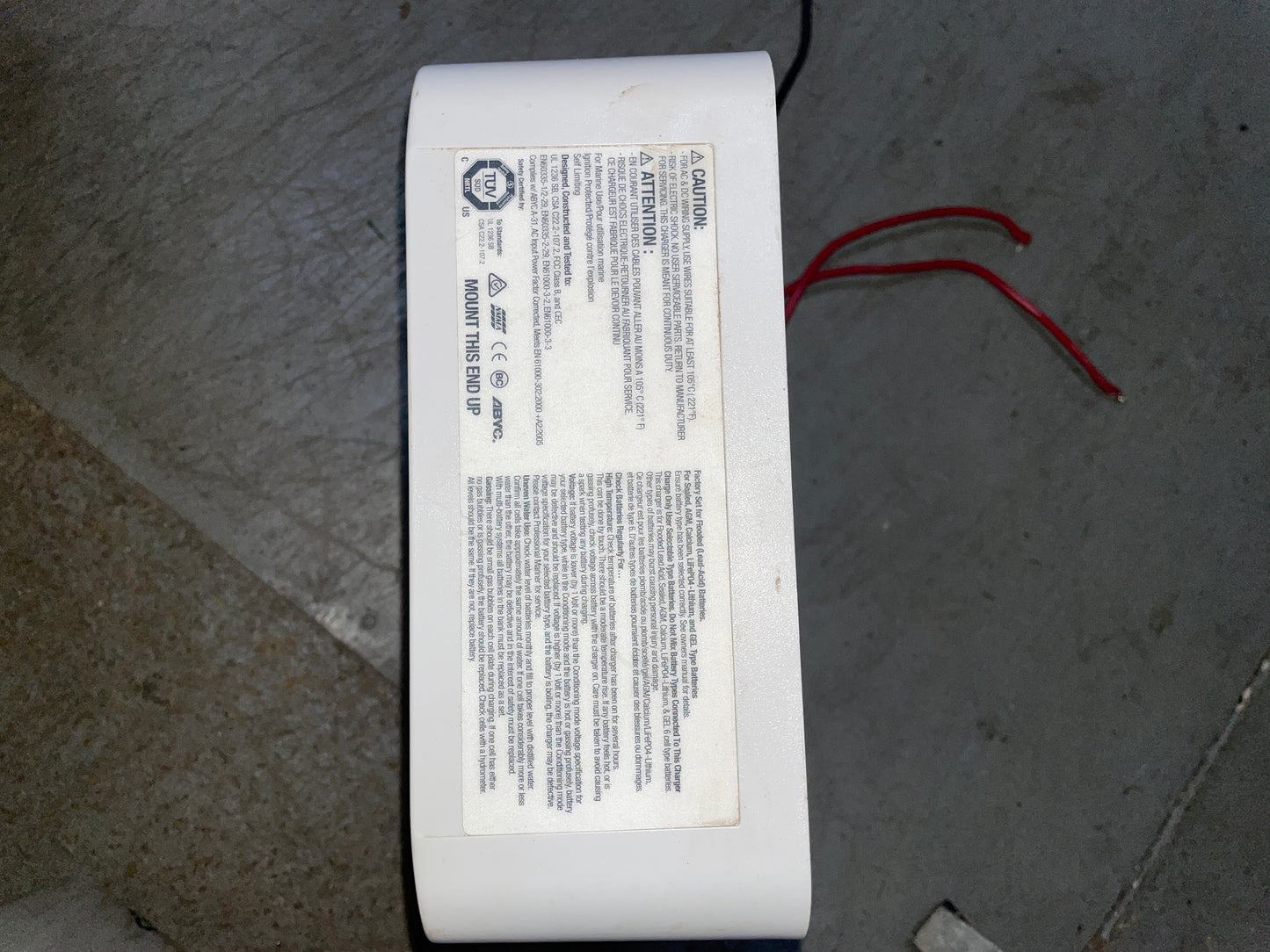 White electronic device with text on a concrete surface