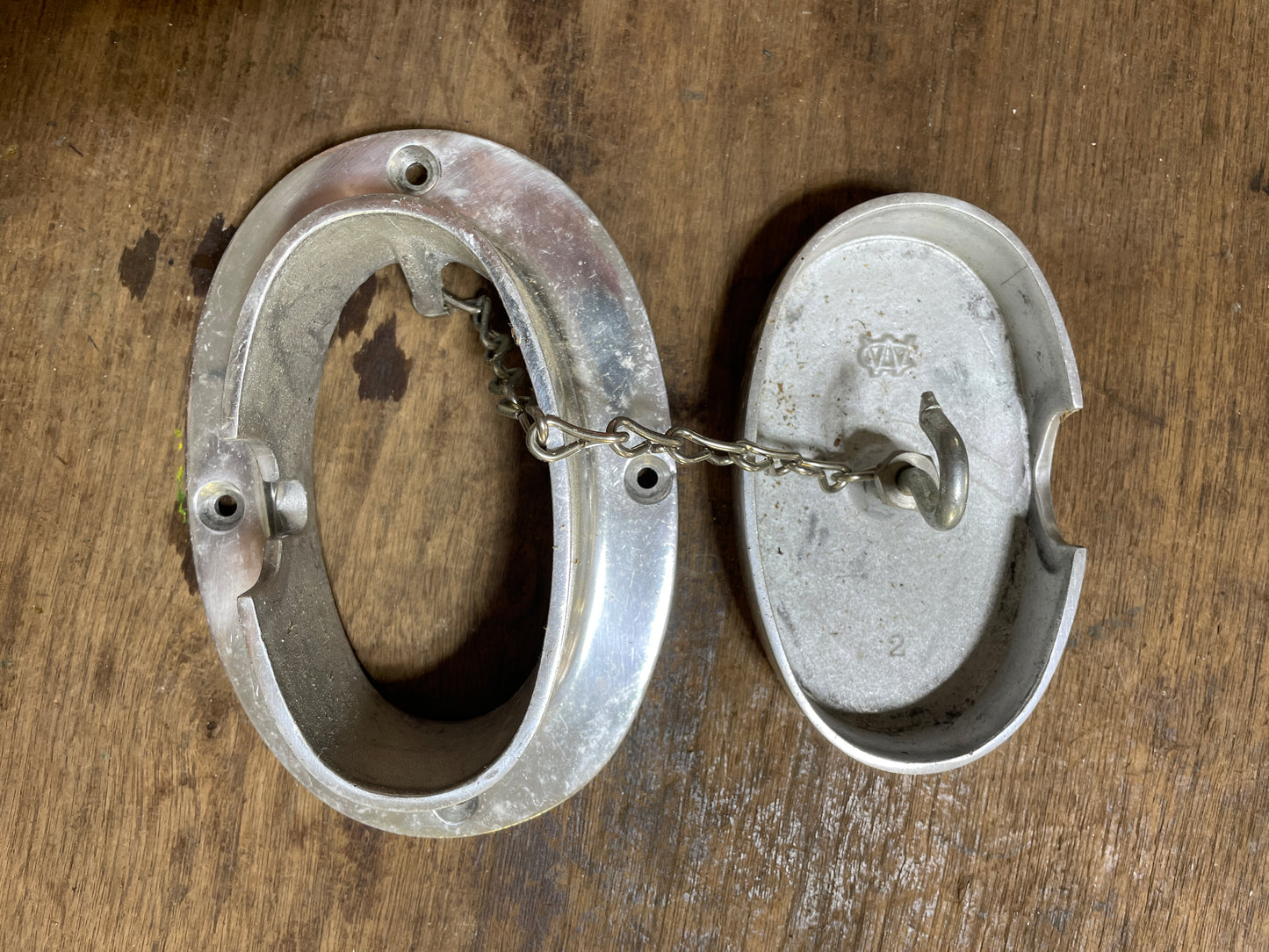 Metal handcuffs on a wooden surface