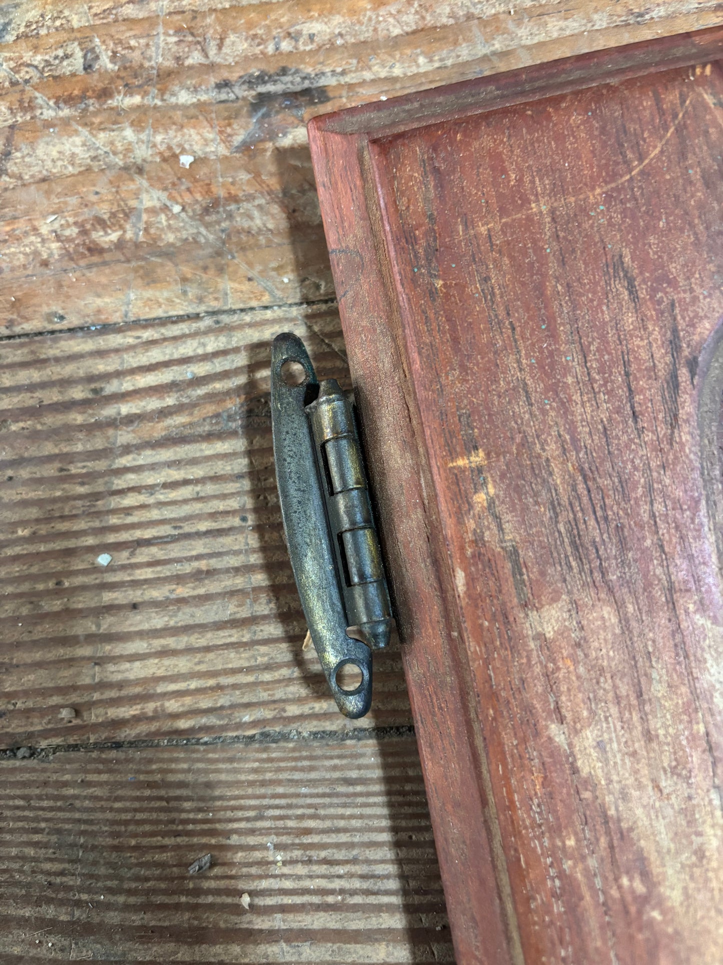 Wooden box with a metal hinge on a wooden surface