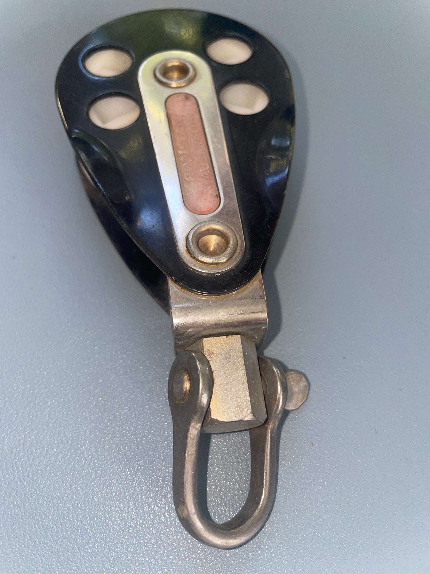 Metallic pulley system on a gray background