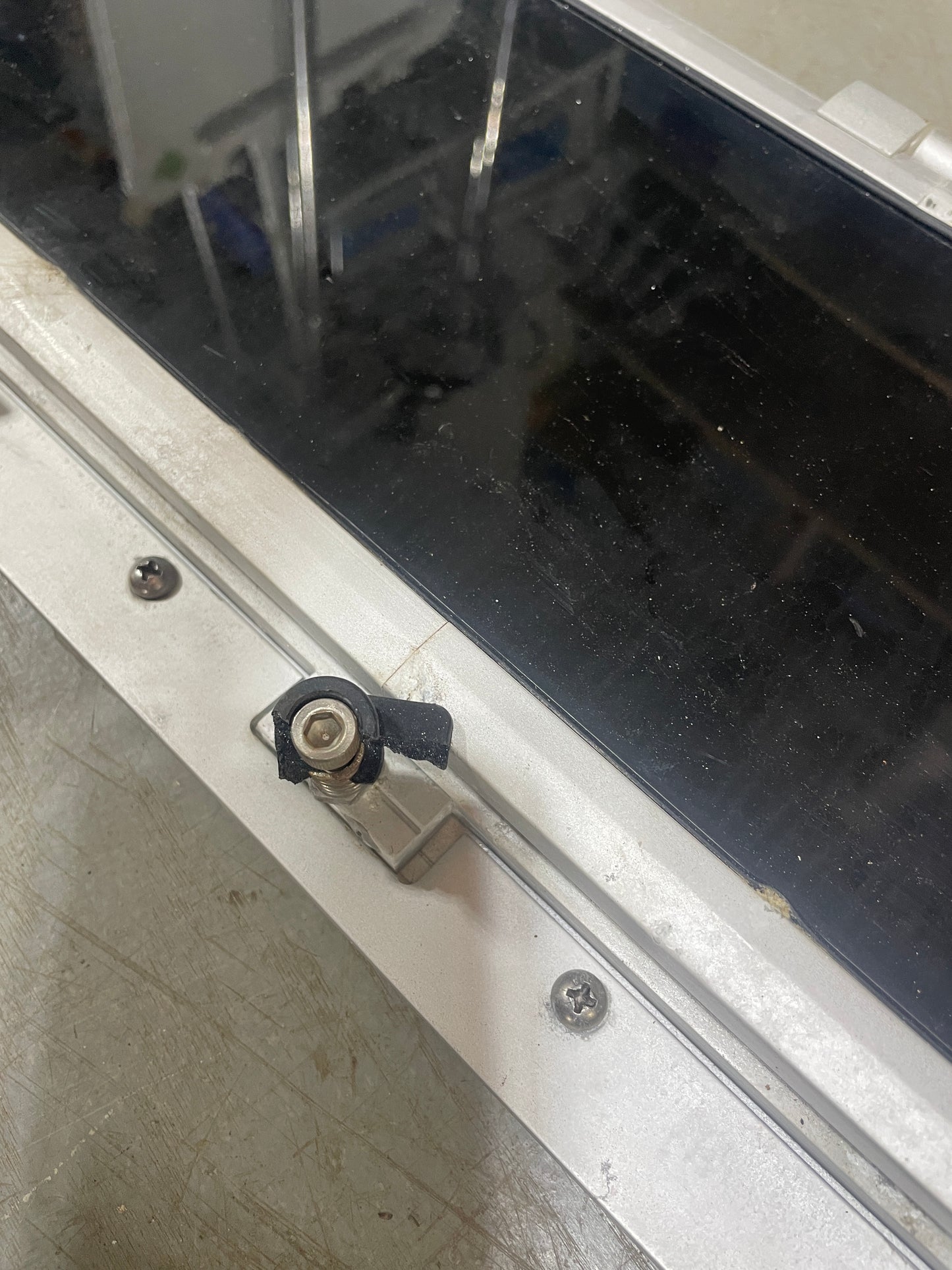 Close-up of a metallic lock mechanism on a glass door
