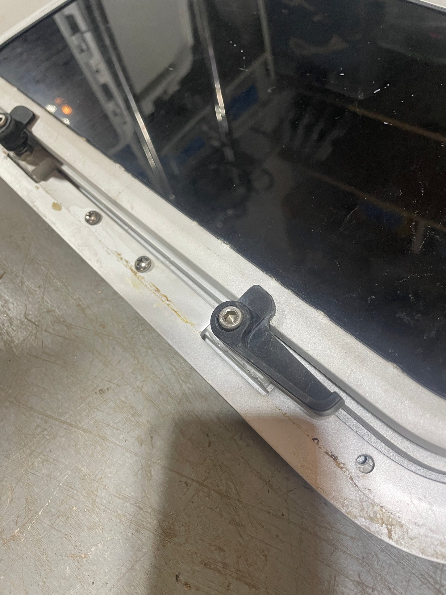 Close-up of a car door handle and window mechanism on a vehicle.