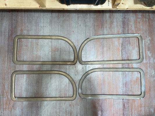 Four metal U-shaped frames on a wooden surface