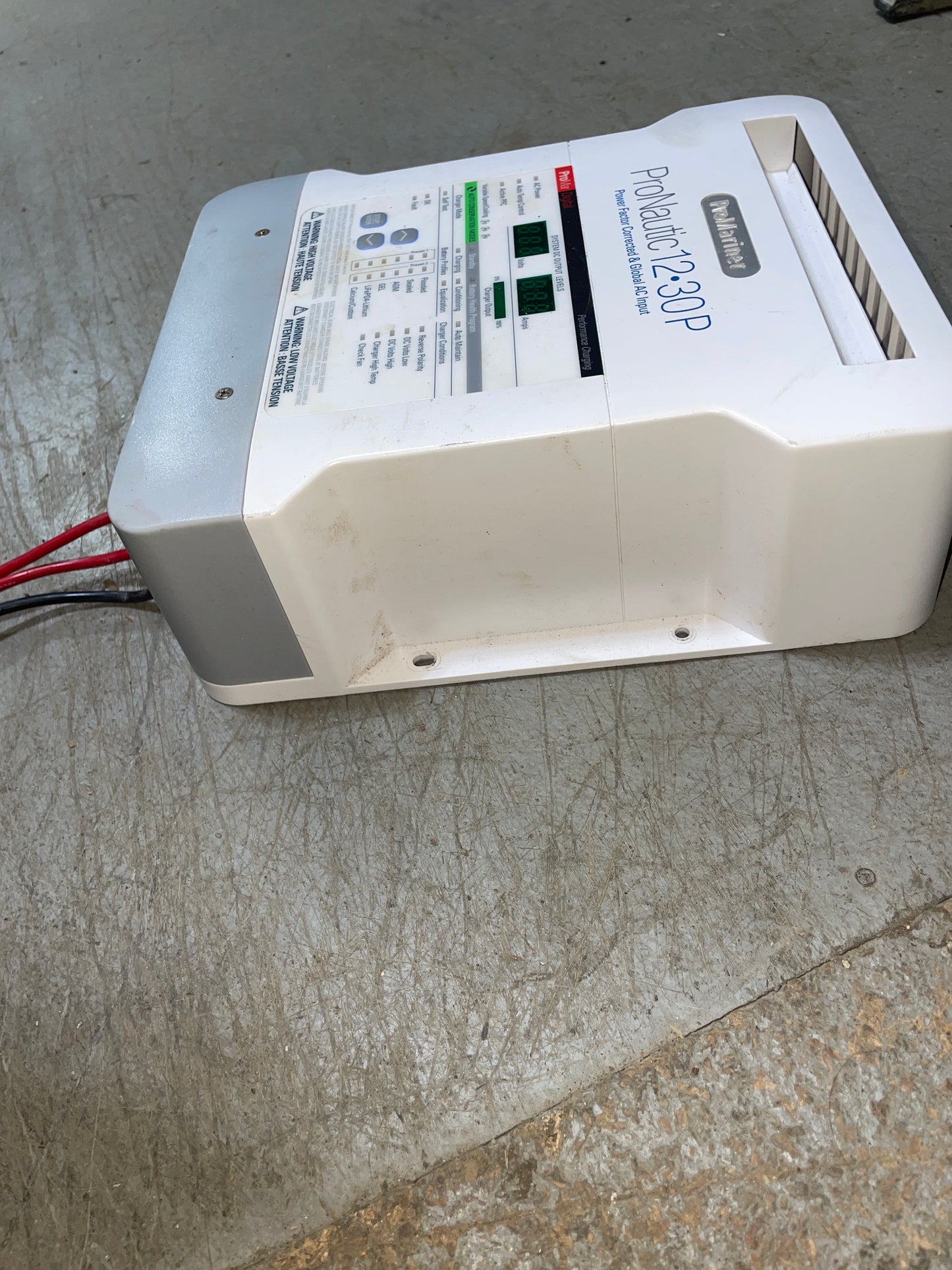 Power inverter labeled 'ProInverter 12-30P' on a concrete floor.