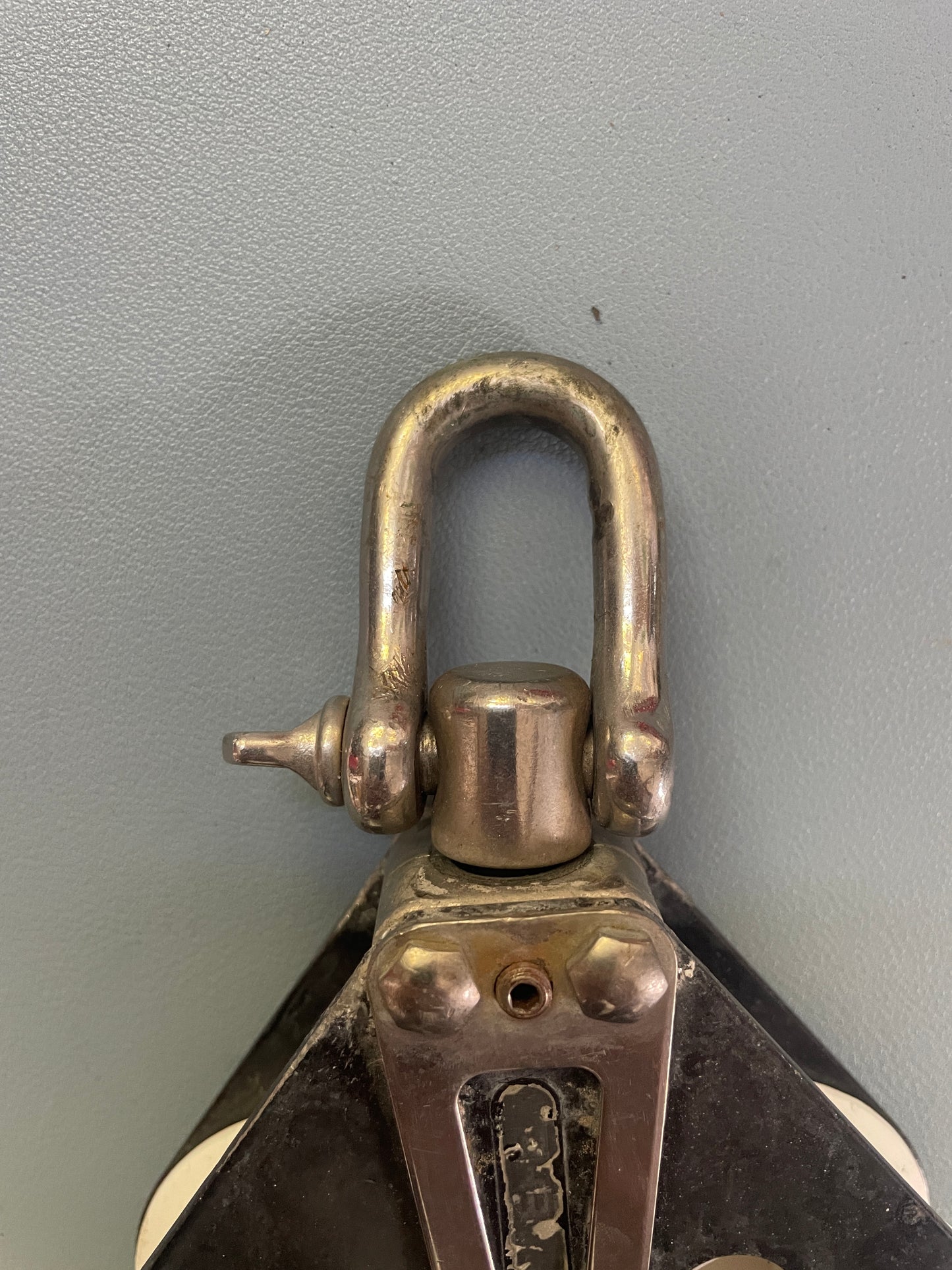 Close-up of a metal clasp on a gray background