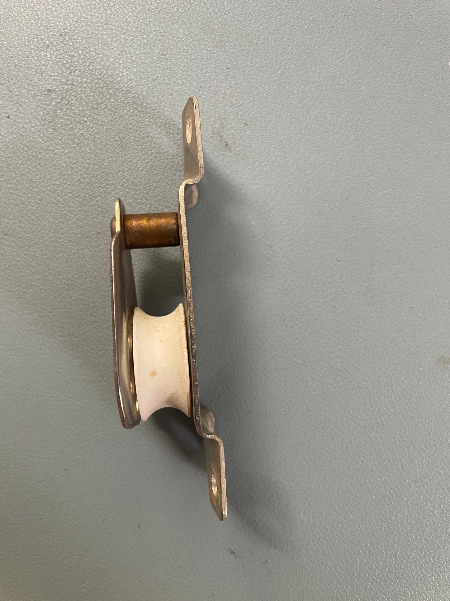 Metal and brass mechanical component on a gray background