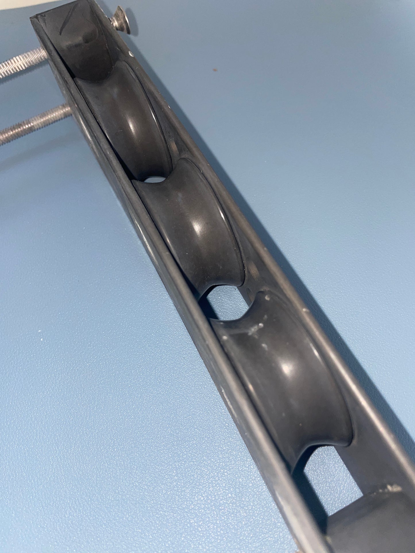 Metal bracket with screws on a light blue background