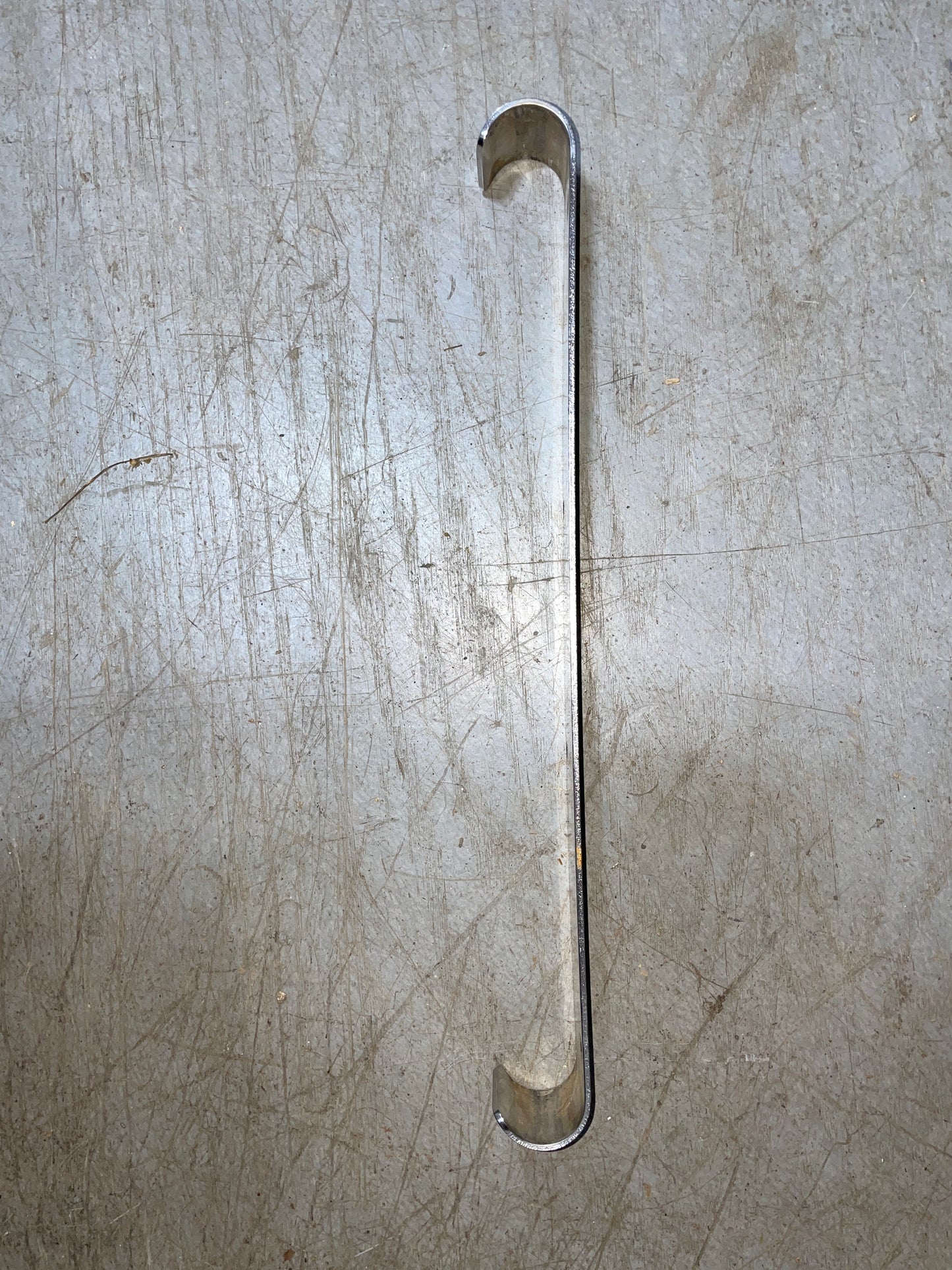 Metallic handle on a textured metallic surface