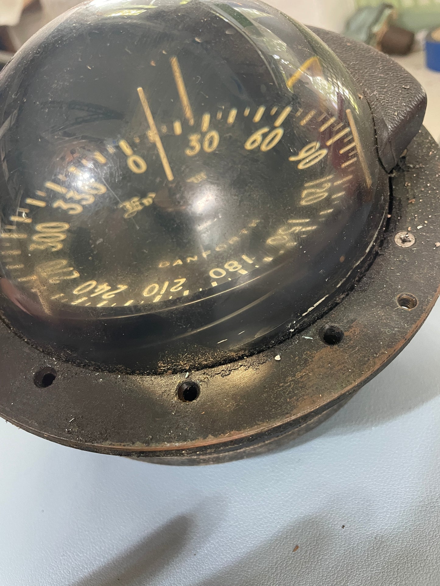 Vintage navigation instrument with a clear lens and black casing on a white background