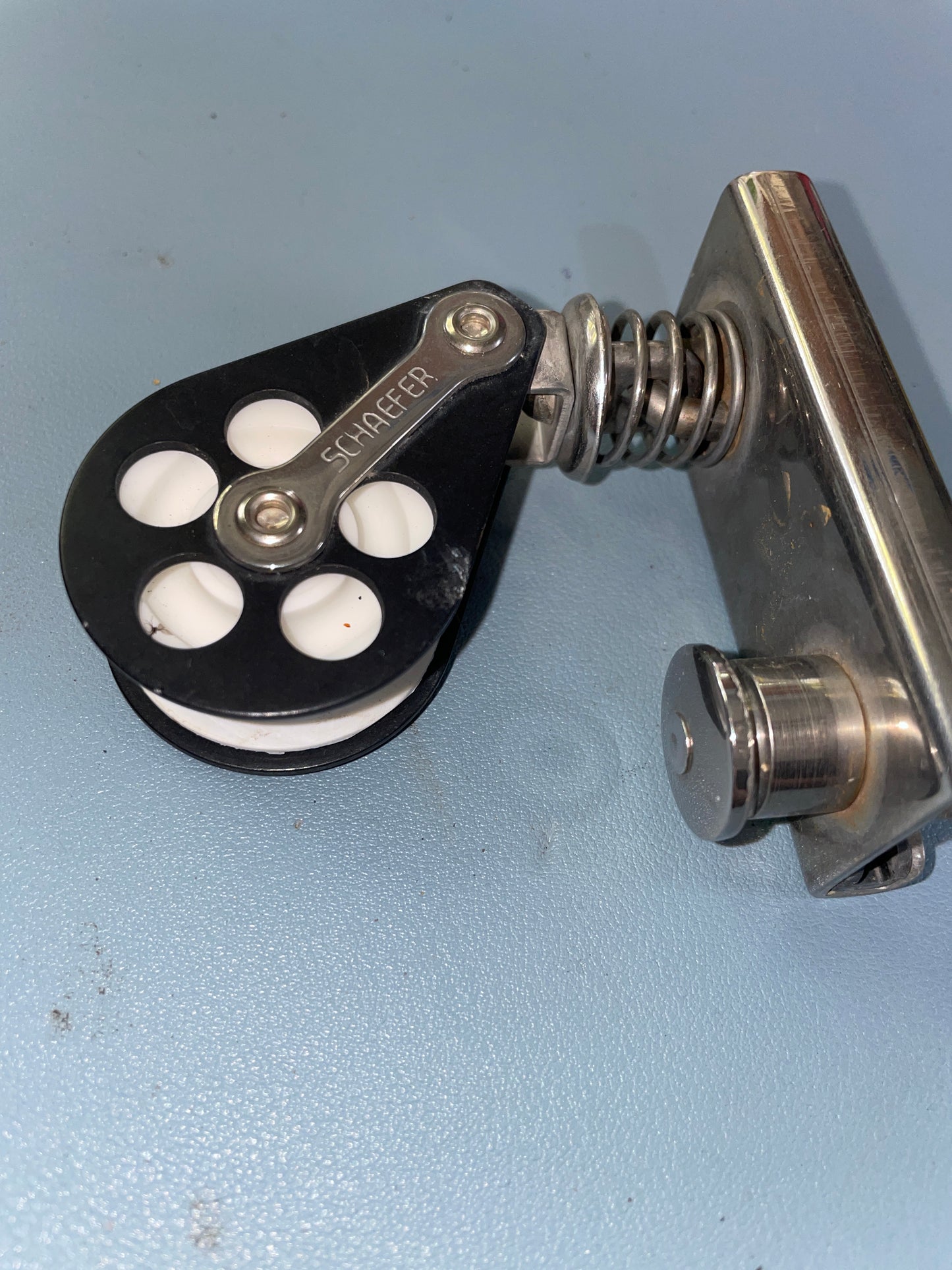 Metal pulley system on a light blue background