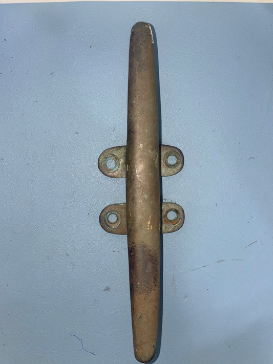 Brass cleat on a light blue background