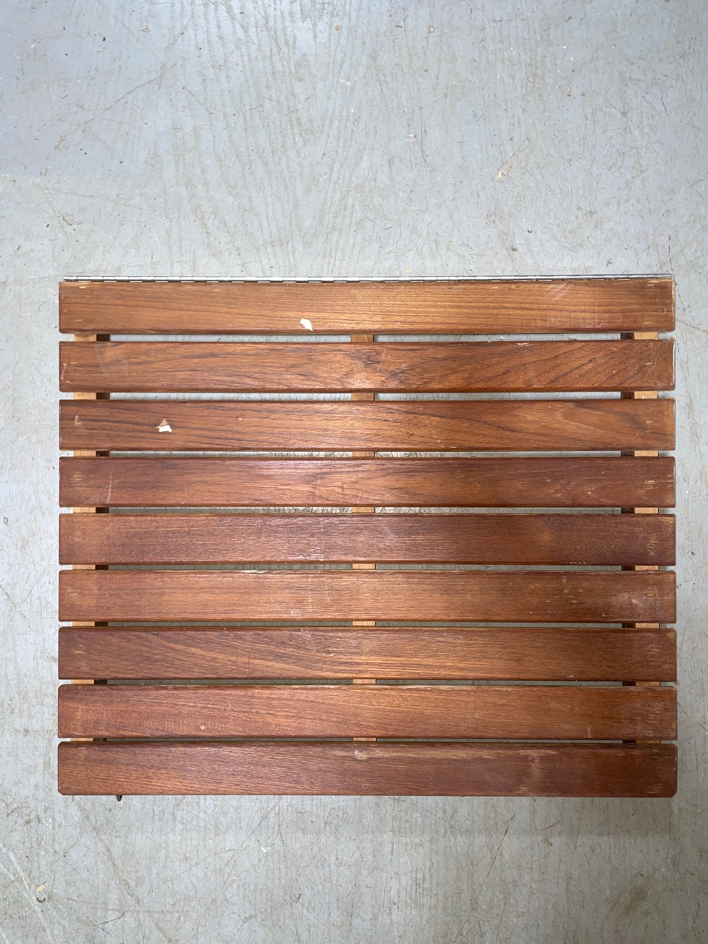 Wooden slatted mat on a concrete floor
