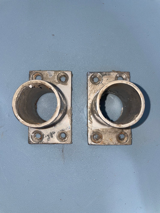 Two metal flanges on a gray background